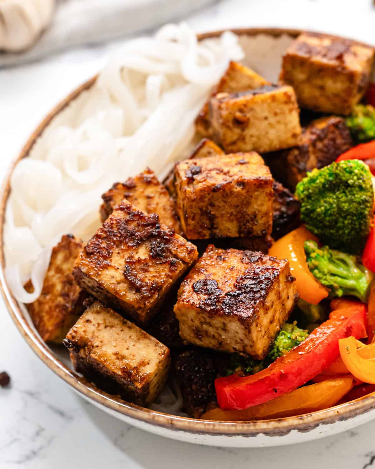 hoisin tofu in a bowl with noodles and vegetables