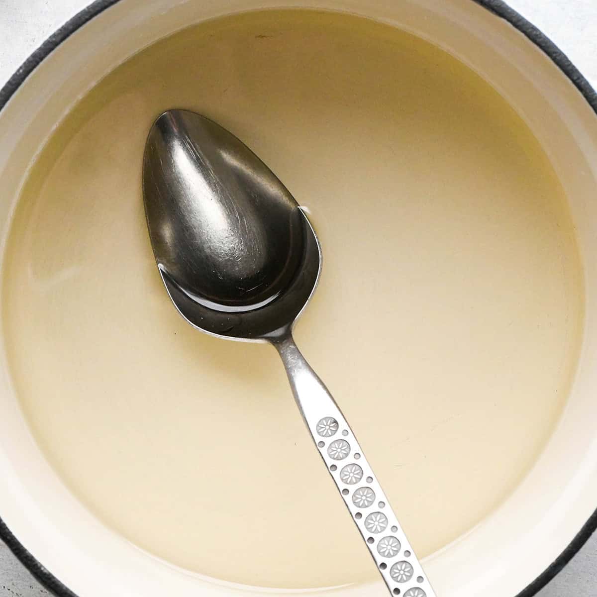 Simple Syrup in a pot with a spoon
