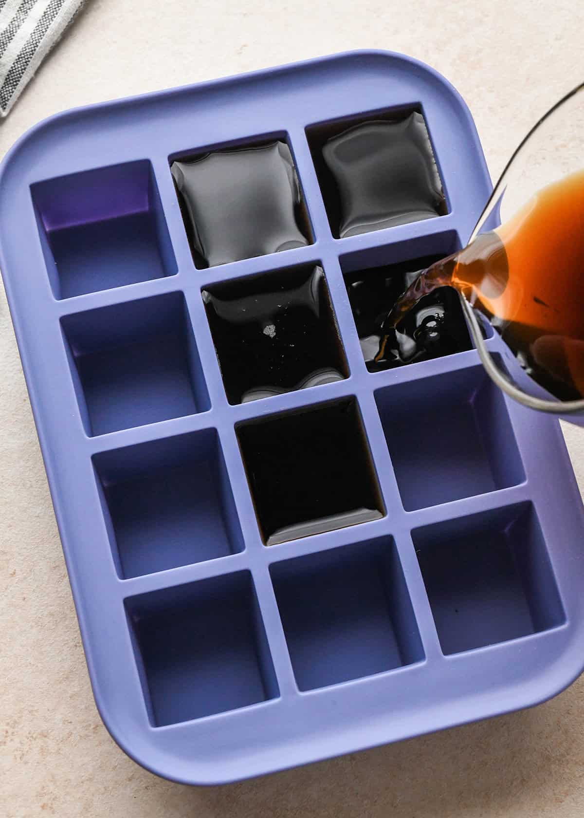 pour coffee into an ice cube tray to make Coffee Ice Cubes