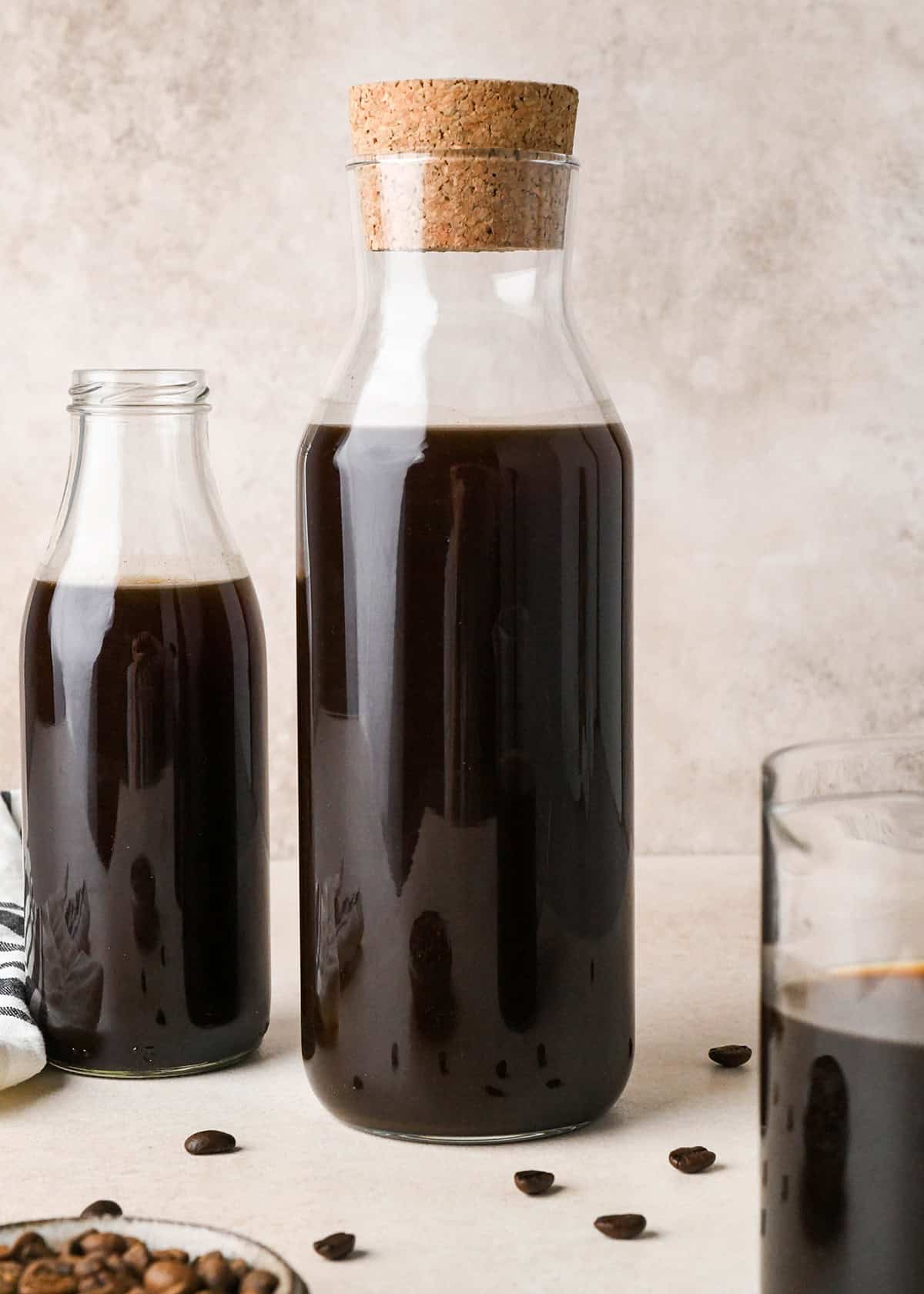 Cold Brew Coffee Recipe in two glass jars, one with a cork lid. 