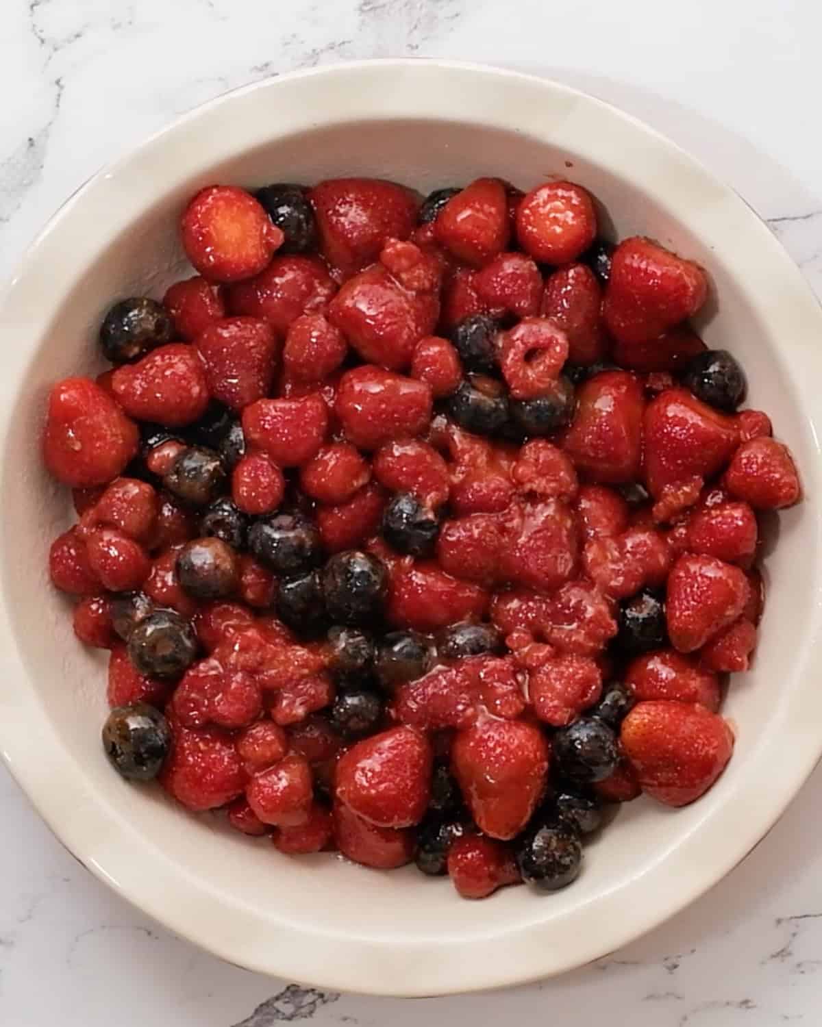How to Make Healthy Berry Crisp -  berry filling in a pie dish