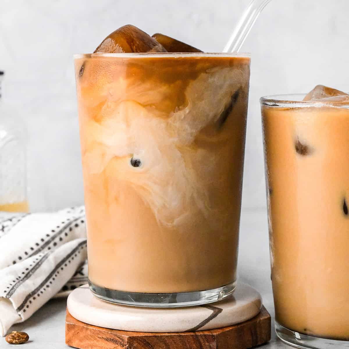 Iced Coffee Recipe in a glass with coffee ice cubes and a straw