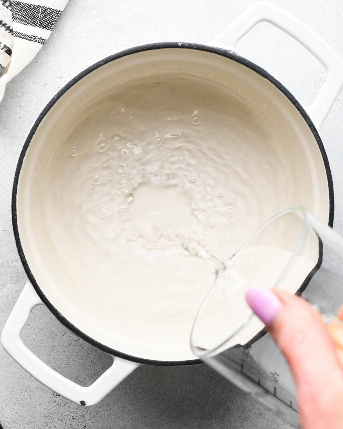how to make simple syrup - pouring water into a pot