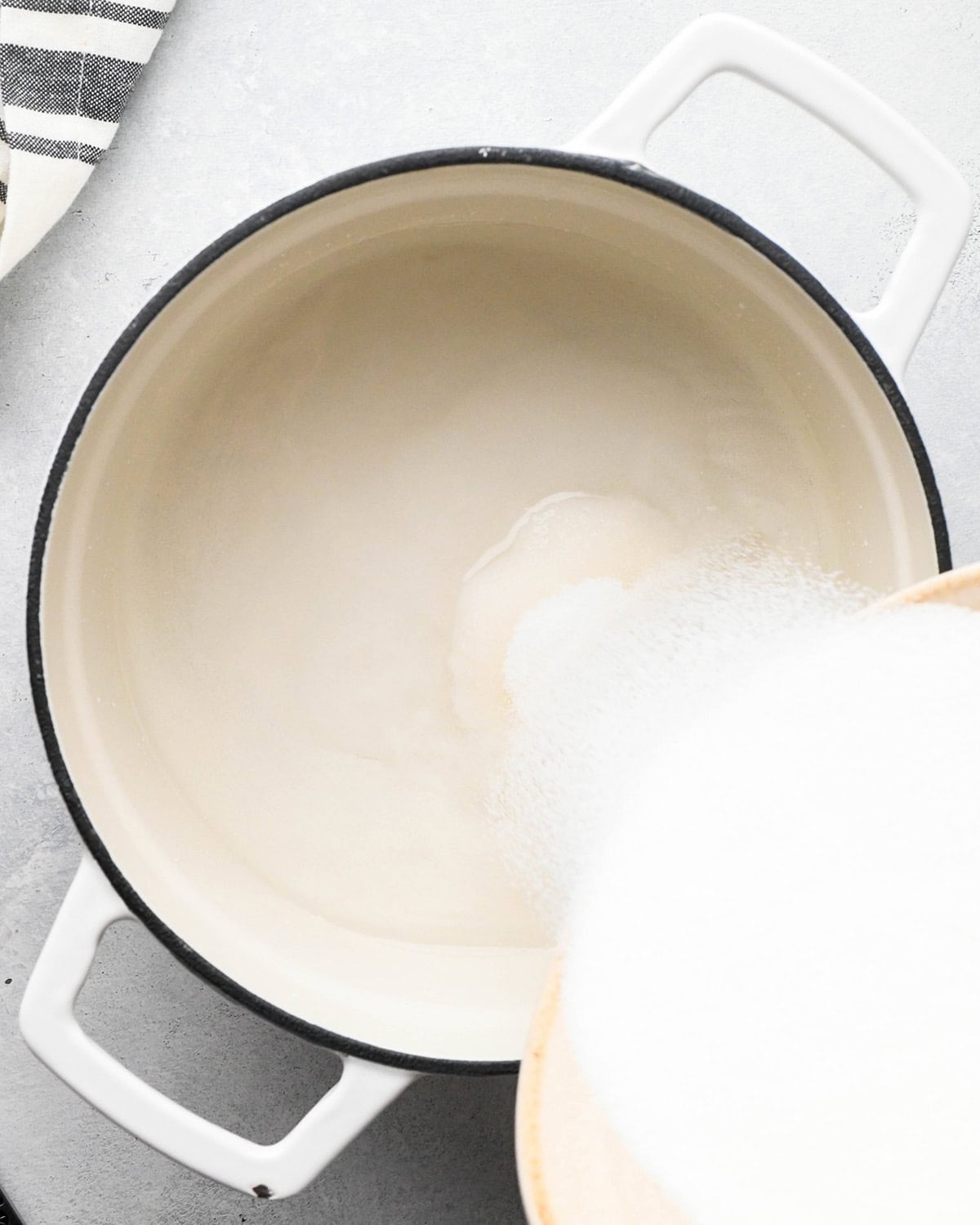 how to make simple syrup - pouring sugar into a pot with water