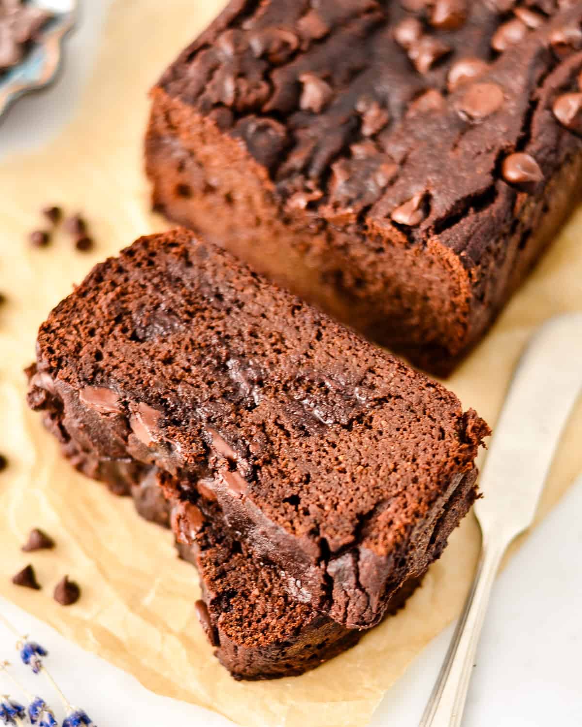 a loaf of Paleo Chocolate Zucchini Bread with two slices cut out of it
