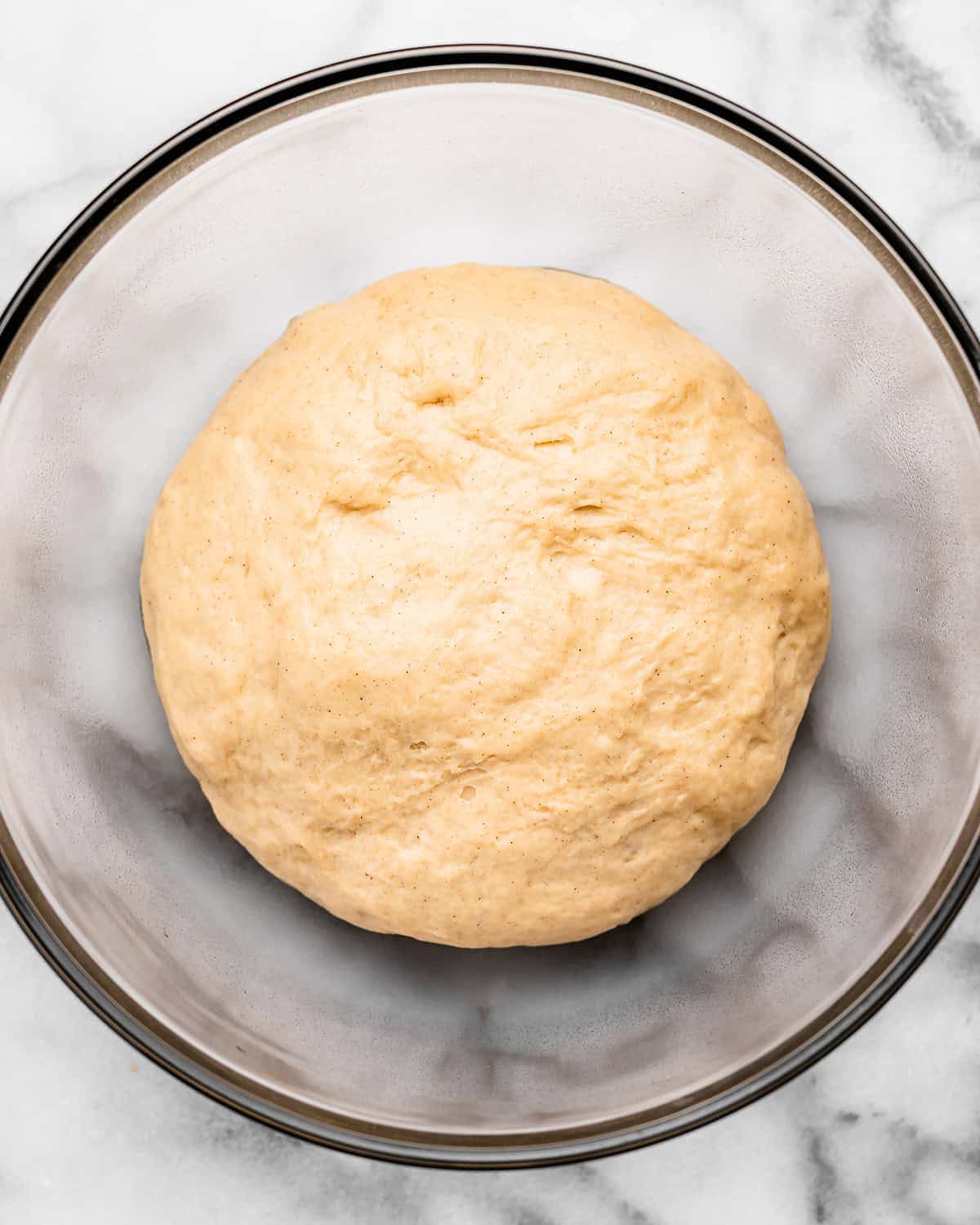 homemade resurrection roll dough in a bowl after rising 