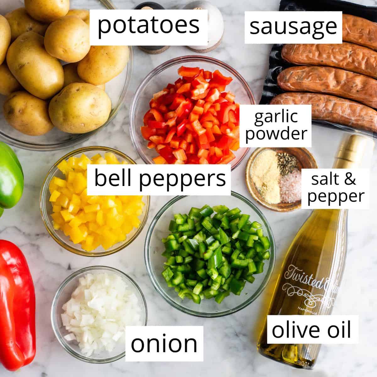 overhead photo of the labeled ingredients in this Sausage and Potatoes and Peppers recipe