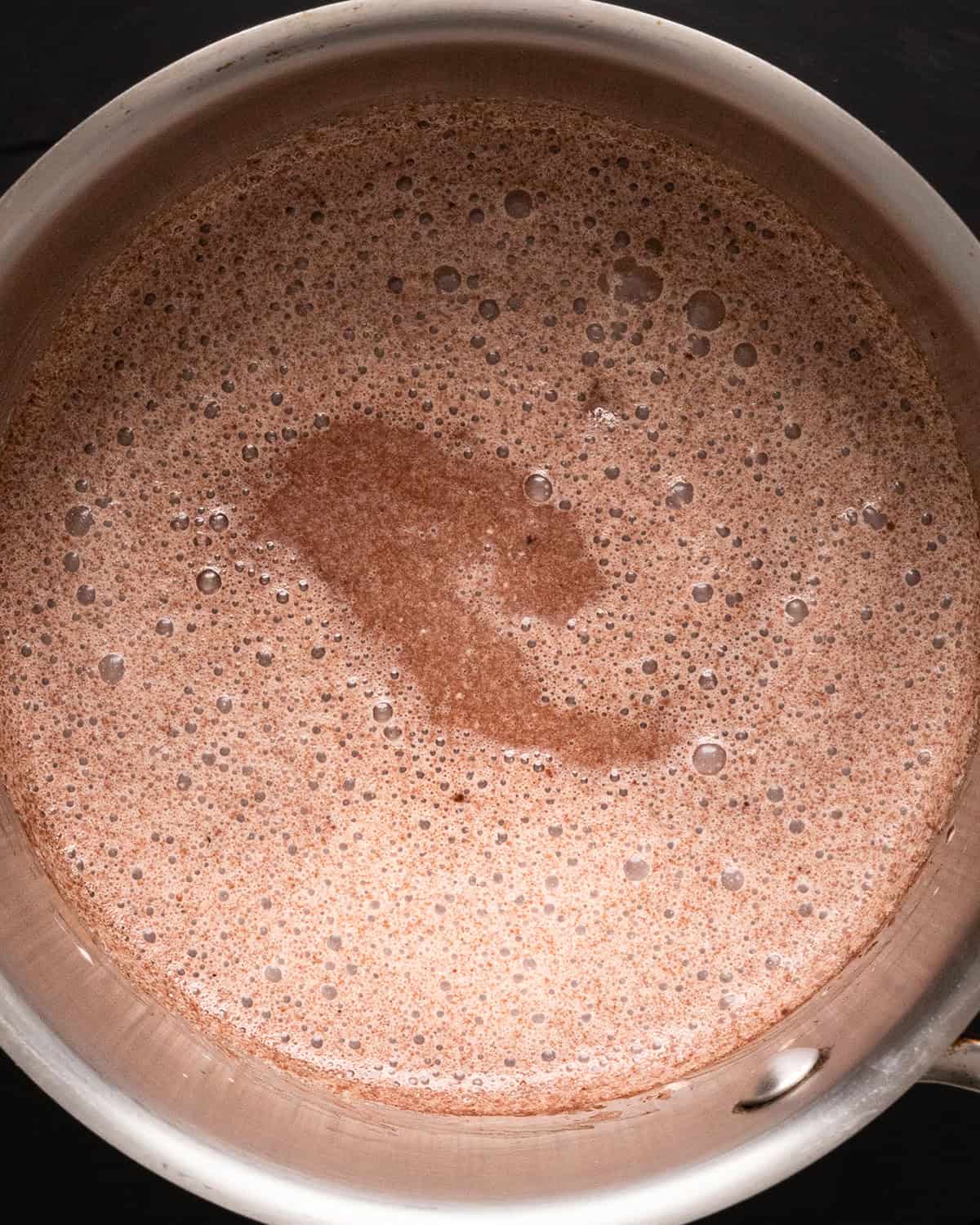 Vegan Chocolate Fondue ingredients in a saucepan after whisking