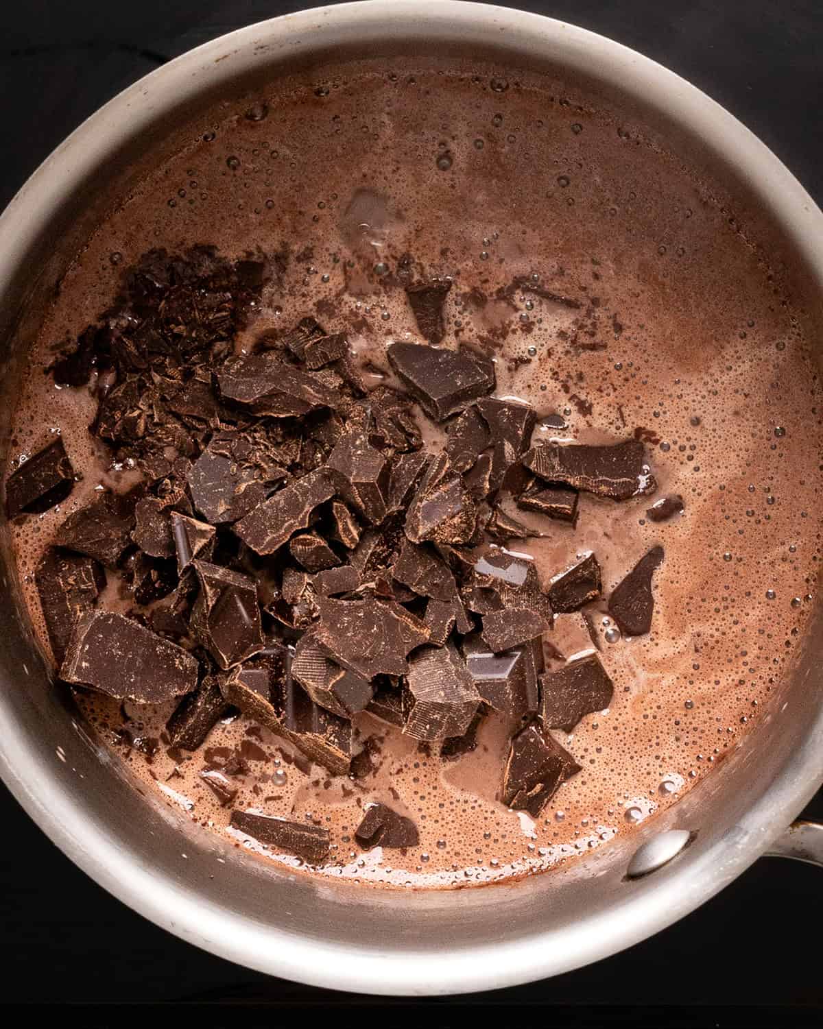 how to make Vegan Chocolate Fondue - adding chocolate to warm coconut cream mixture
