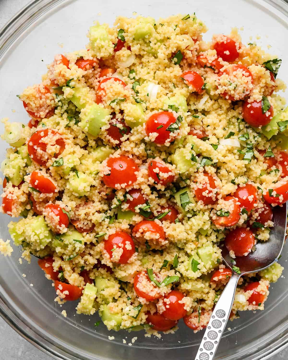 Couscous Salad stirred in a bowl with a spoon