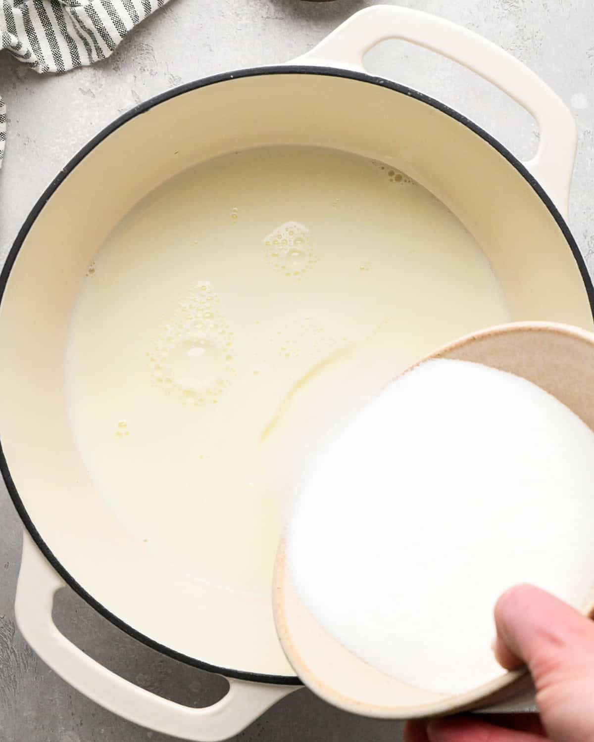 making Mint Chocolate Chip Ice Cream - adding sugar to milk in a pot