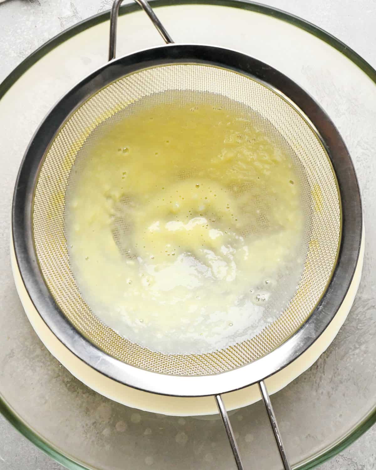 metal strainer after the custard has been strain through it