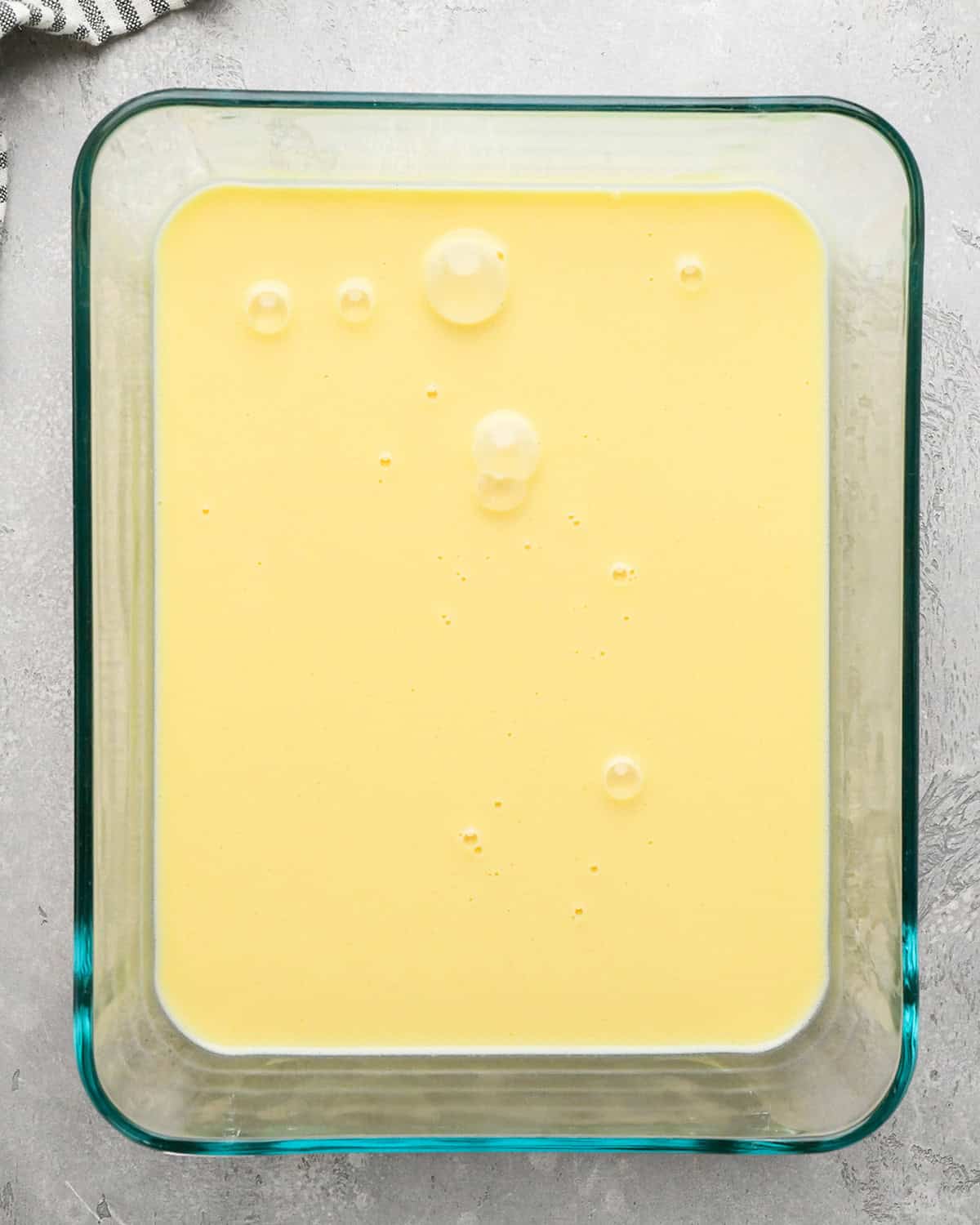 Mint Chocolate Chip Ice Cream base in a glass container before chilling