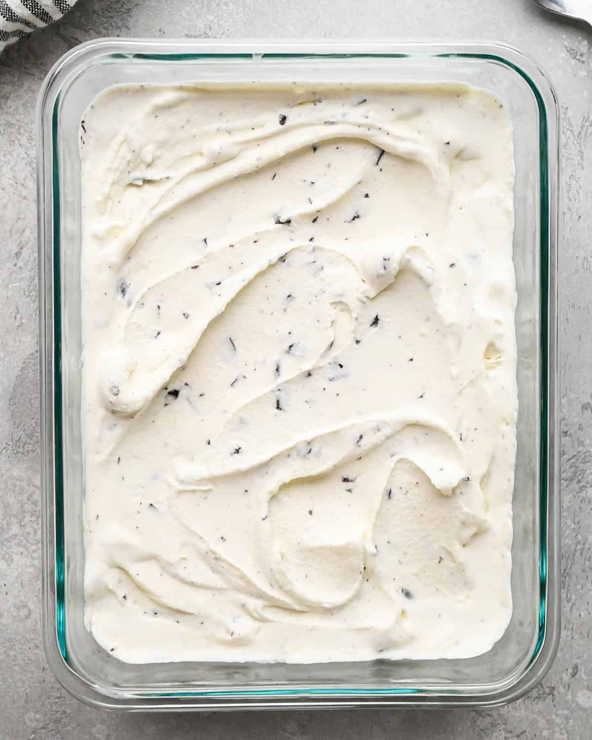 Mint Chocolate Chip Ice Cream in a glass container before freezing