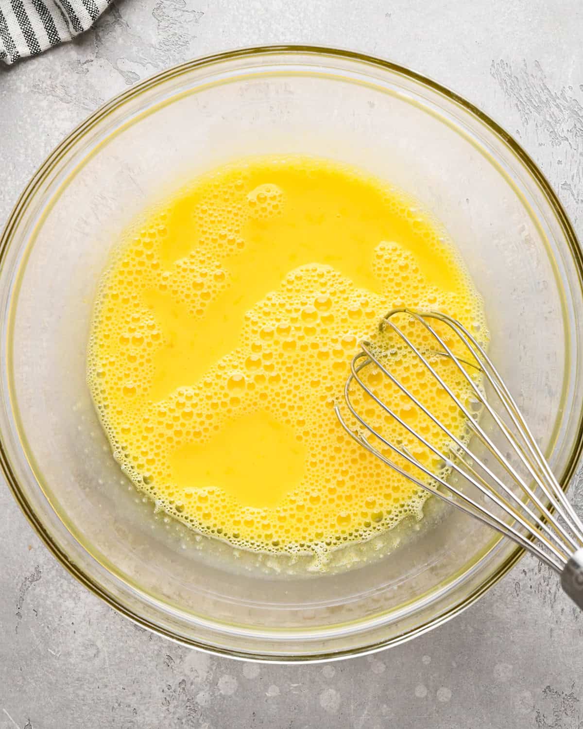 making Mint Chocolate Chip Ice Cream - milk whisked into egg yolks