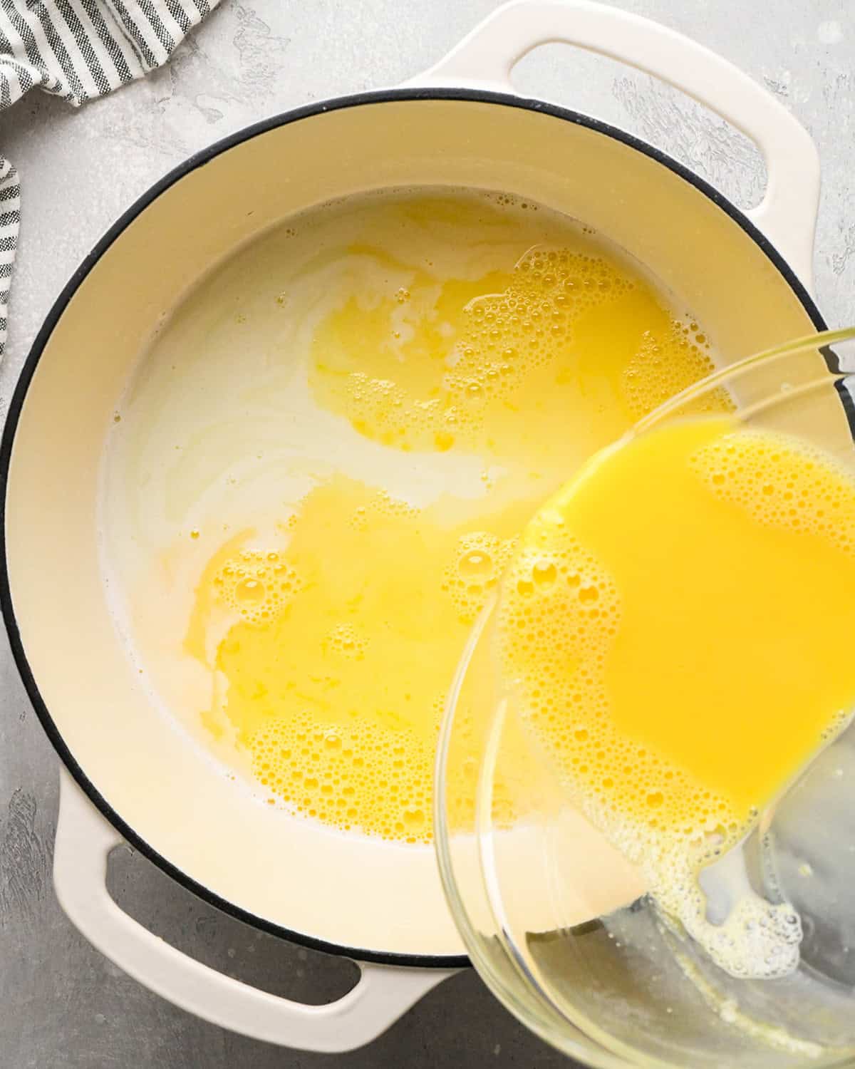 making Mint Chocolate Chip Ice Cream - pouring milk and egg mixture back into the pot with milk