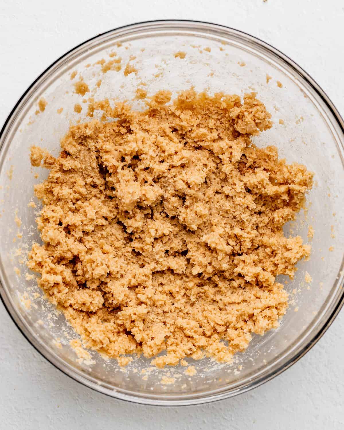 making s'mores cookies recipe - butter and sugars beaten together in a glass mixing bowl