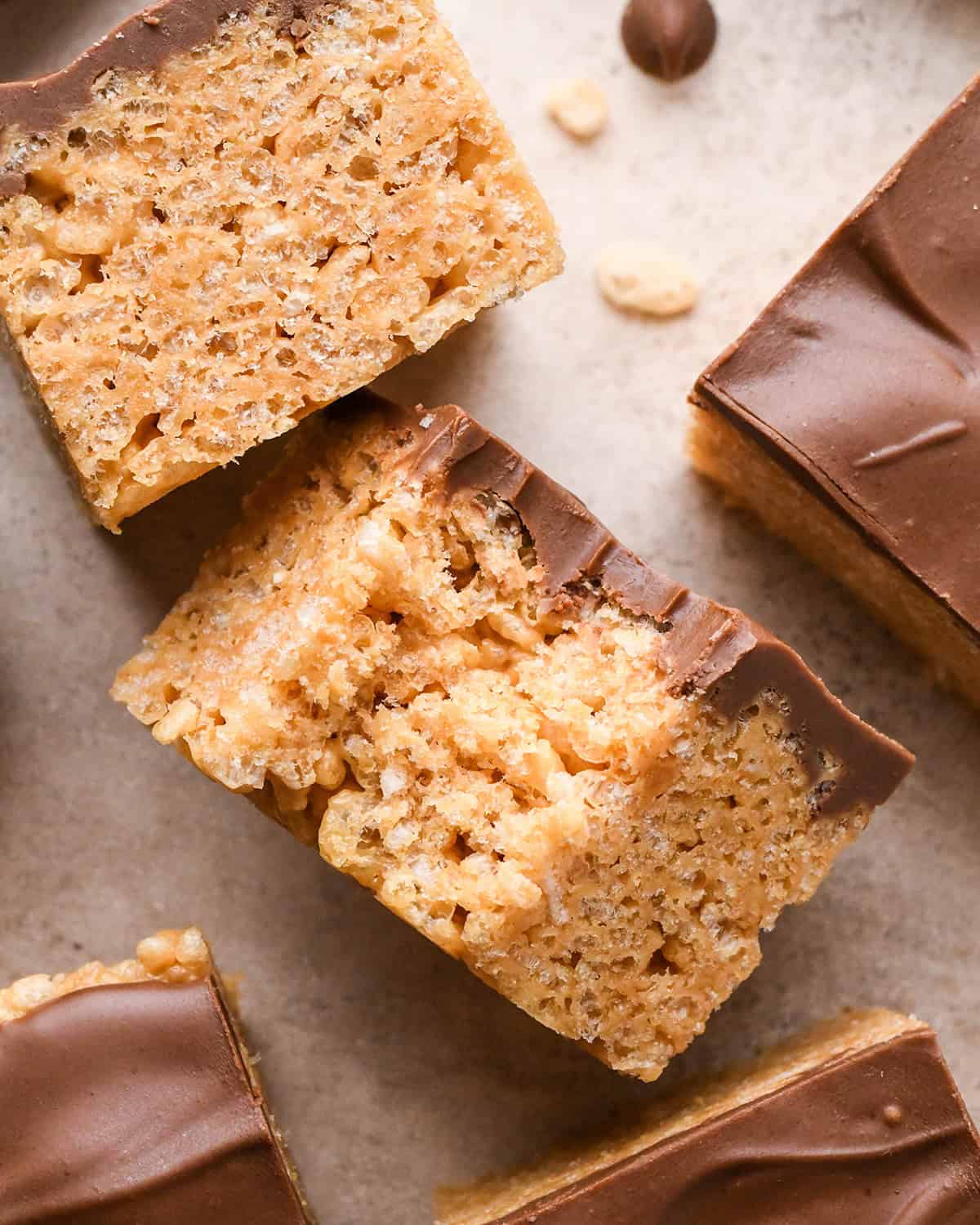 two Peanut Butter Rice Crispy Treats, one with a bite taken out of it