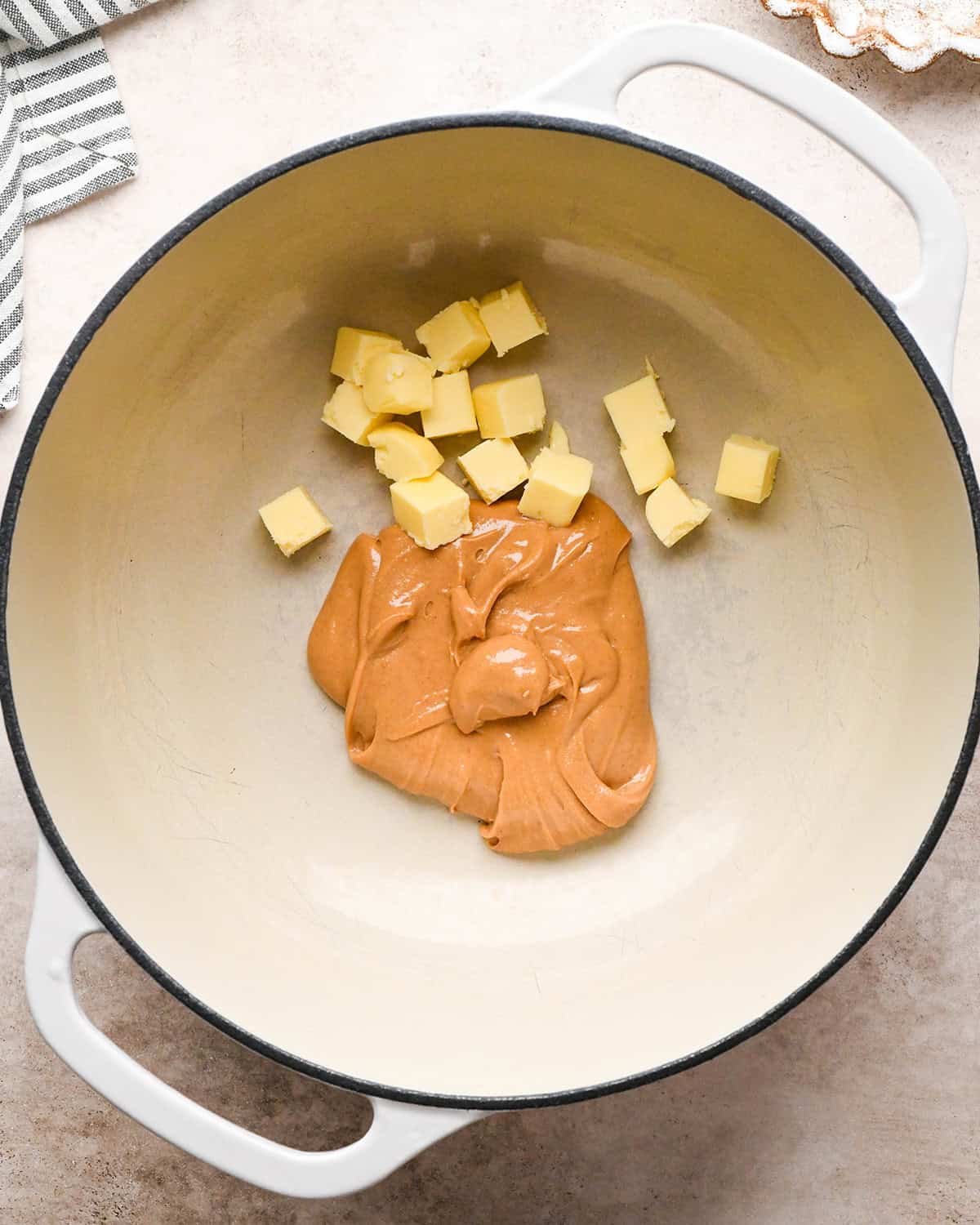 making Peanut Butter Rice Crispy Treats - butter and peanut butter in a pan before melting