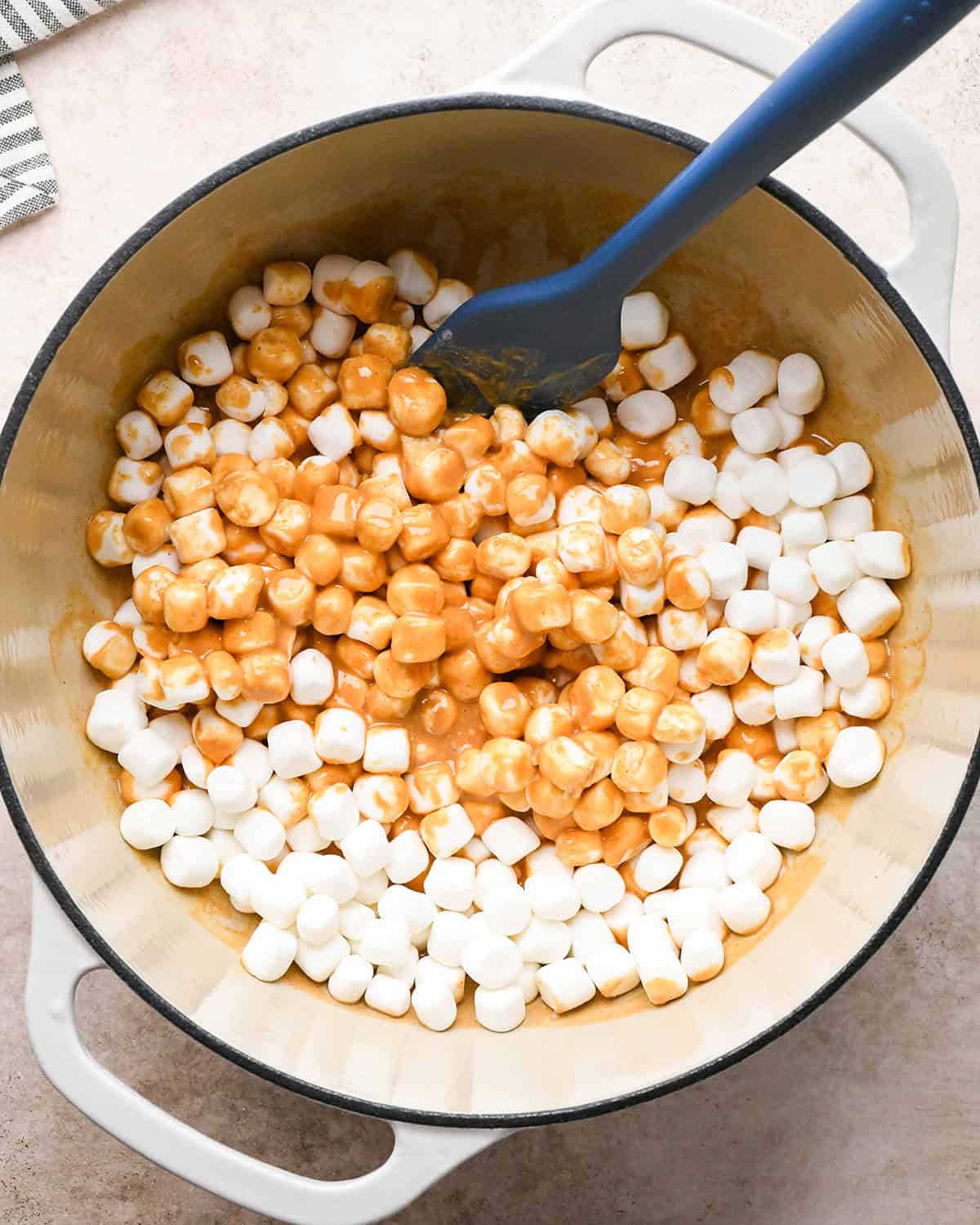 making Peanut Butter Rice Crispy Treats - stirring marshmallows into peanut butter