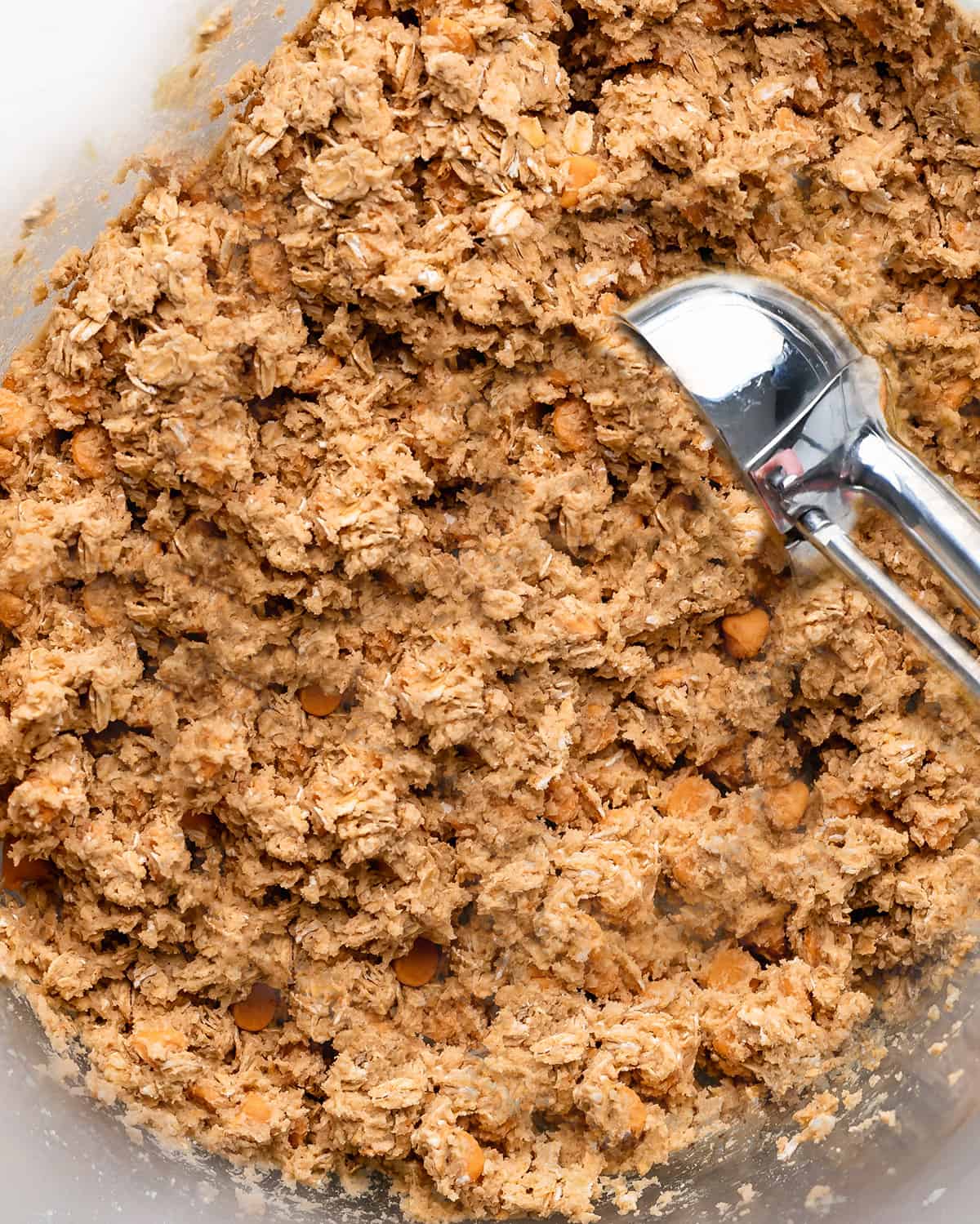 how to make Oatmeal Butterscotch Cookies  - a cookie scoop measuring out dough