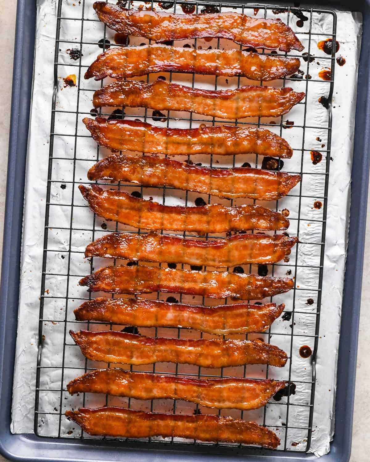 Making maple bacon - overhead photo of crispy maple-glazed bacon strips after they've been baked in the oven