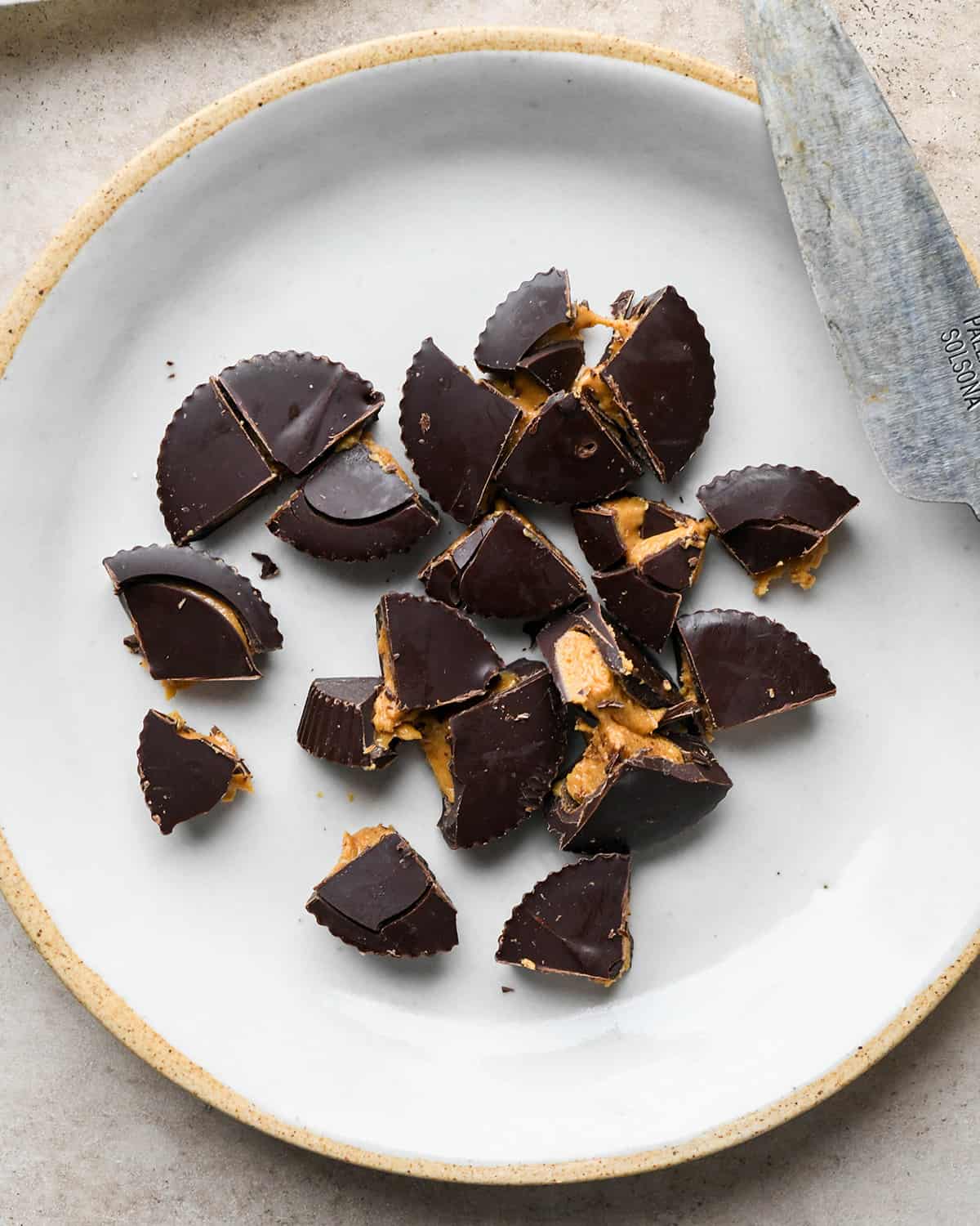 assembling Peanut Butter Cup Brownies - chopped peanut butter cups on a plate for the top