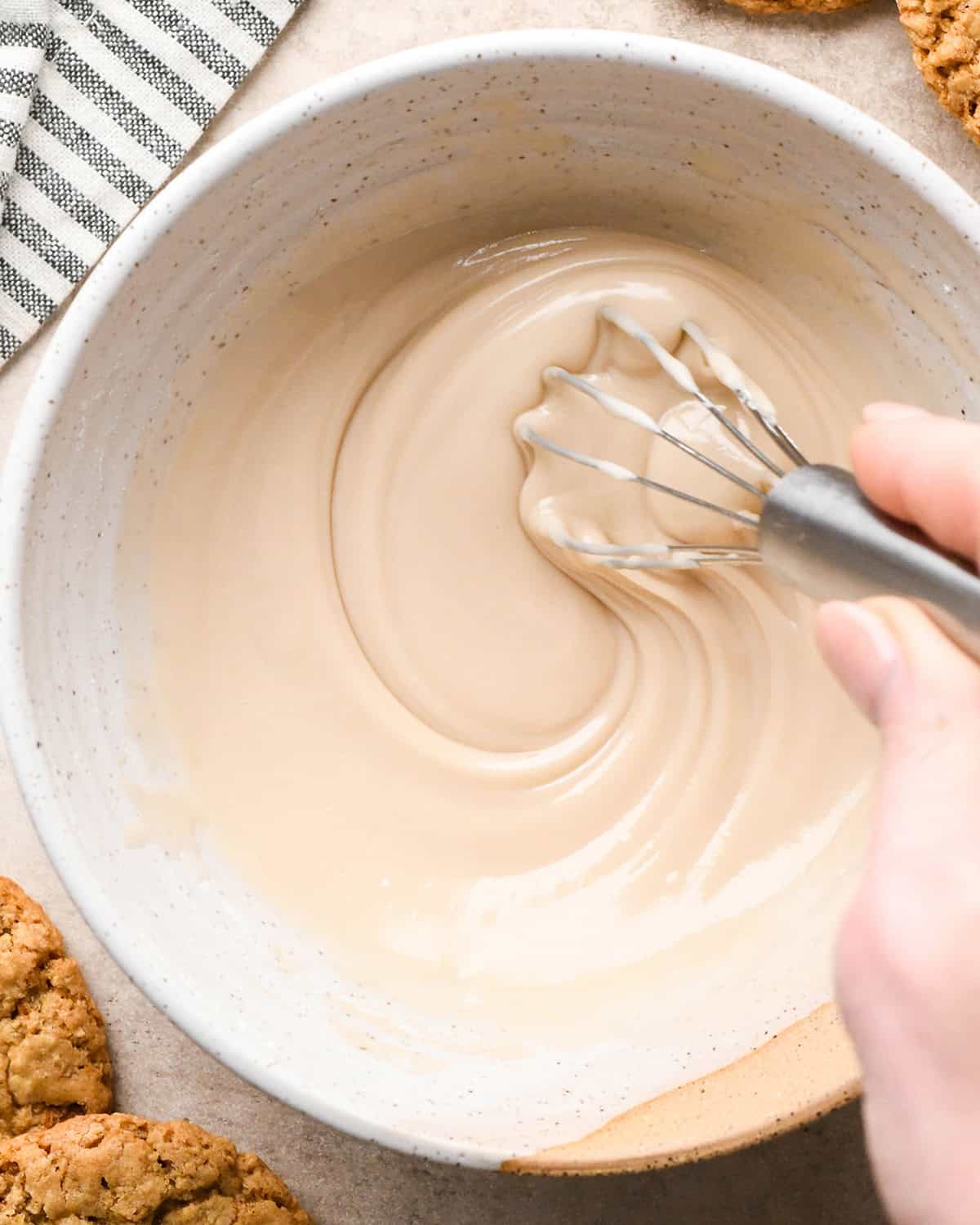 vanilla icing being whisked in a bowl