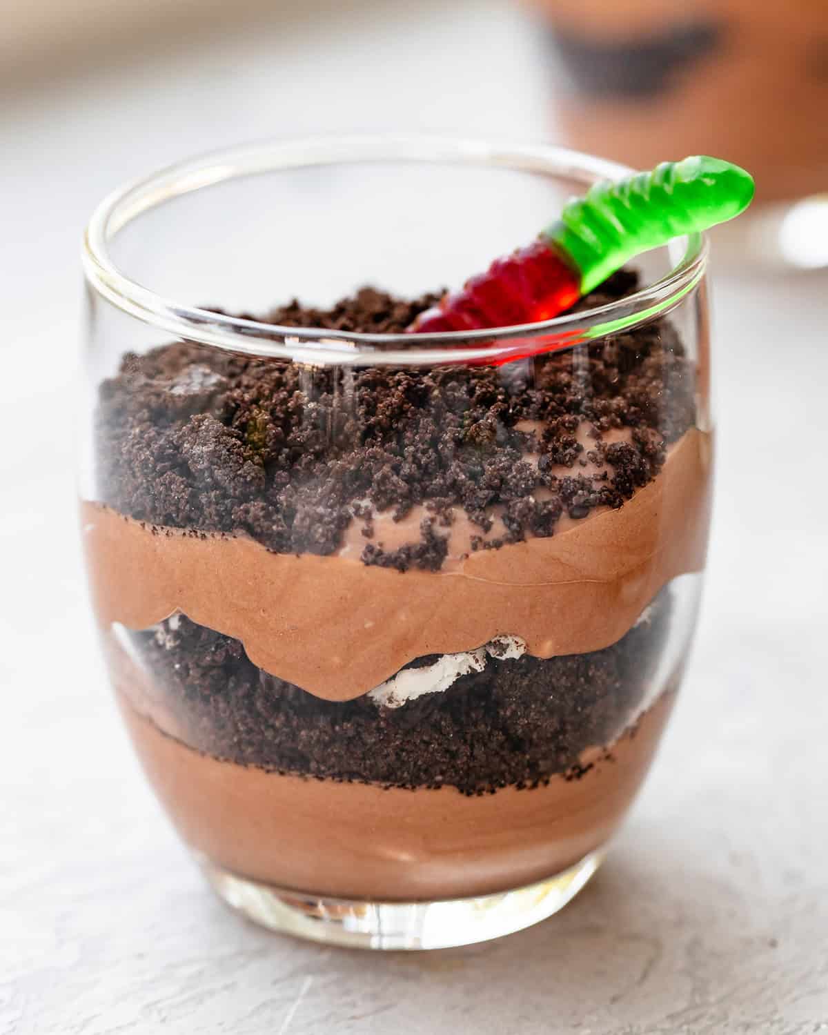 dirt pudding cup assembled with a gummy worm on top