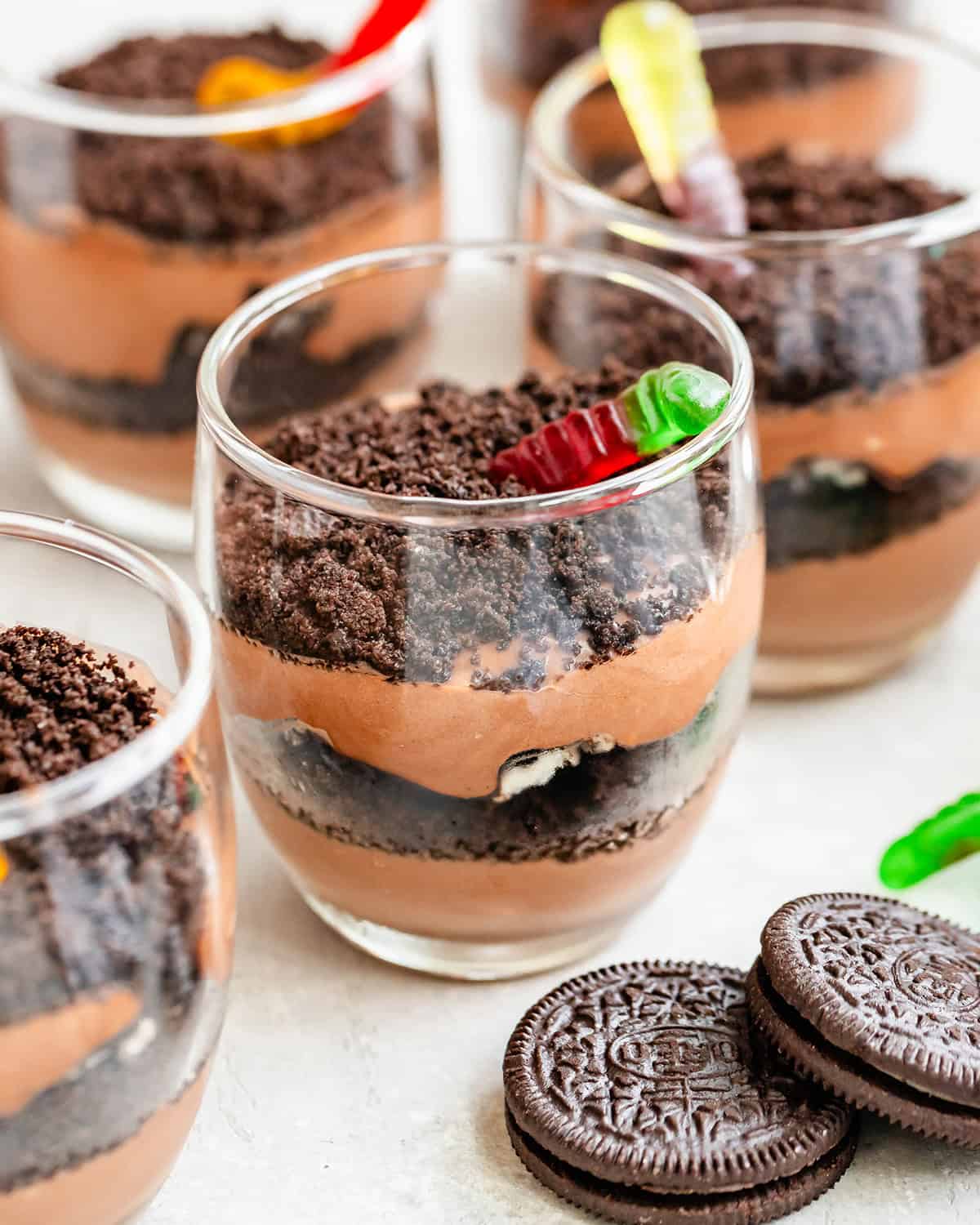 4 dirt cups in glass cups with gummy worms 