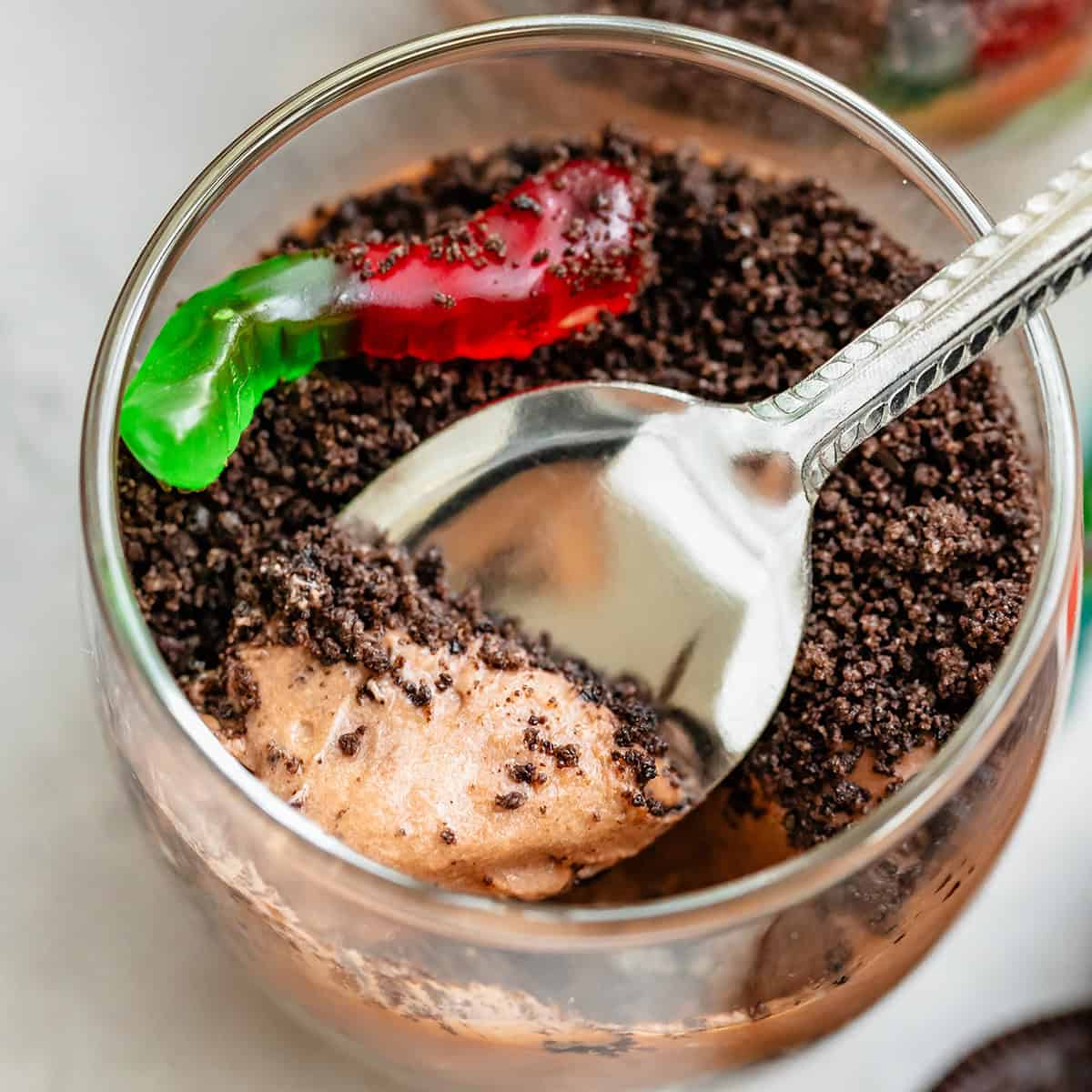 a spoon taking a scoop out of a dirt pudding cup