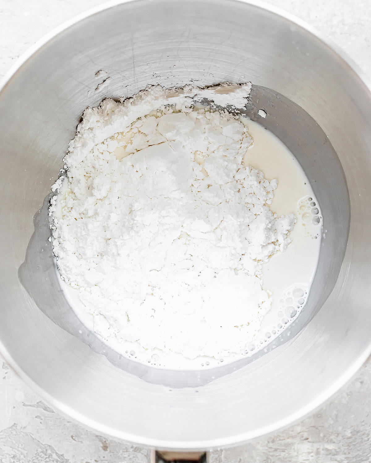 How to Make Dirt Cups - powdered sugar and whipping cream in a bowl before beating