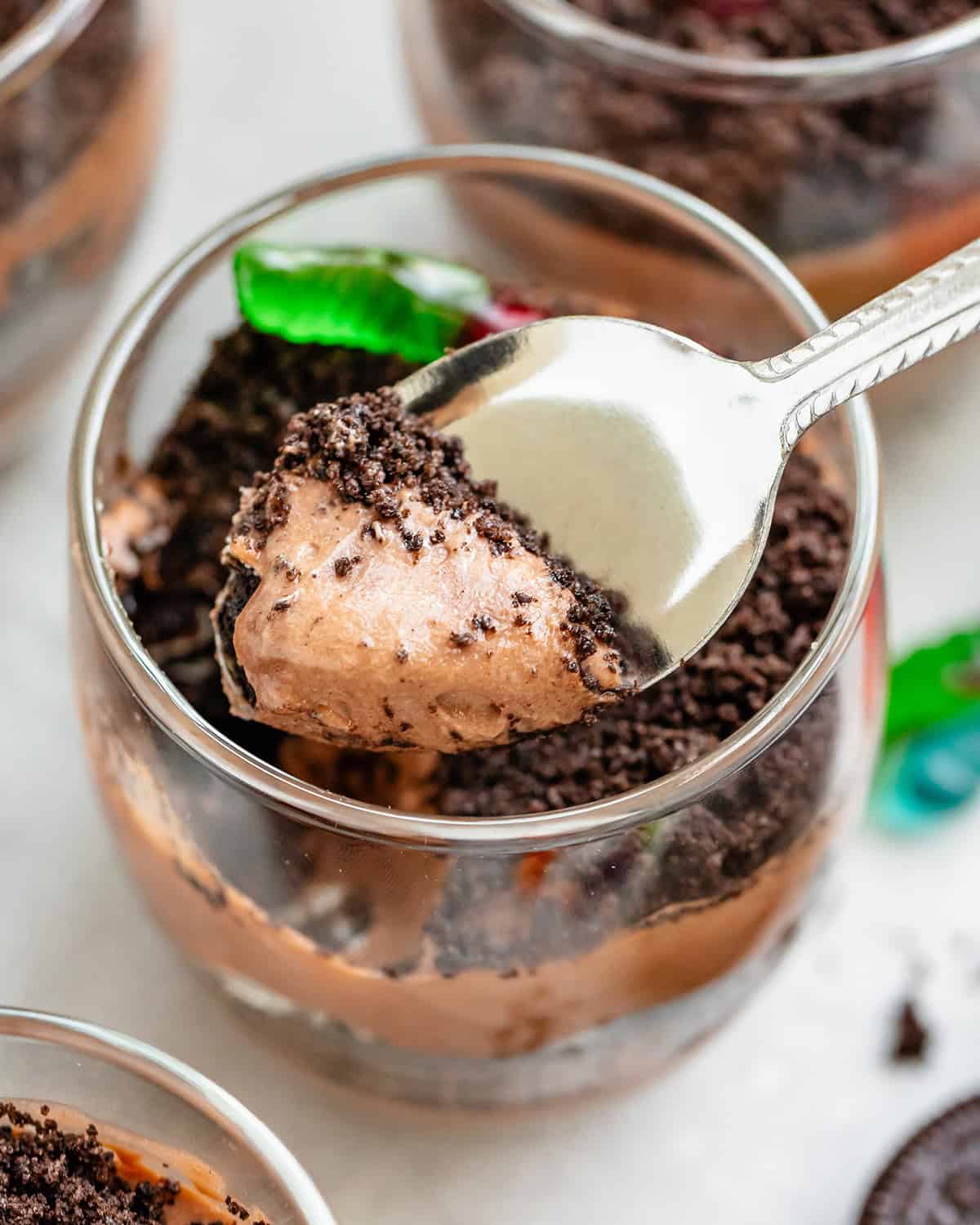 a spoon with a scoop of pudding over a Dirt Cup