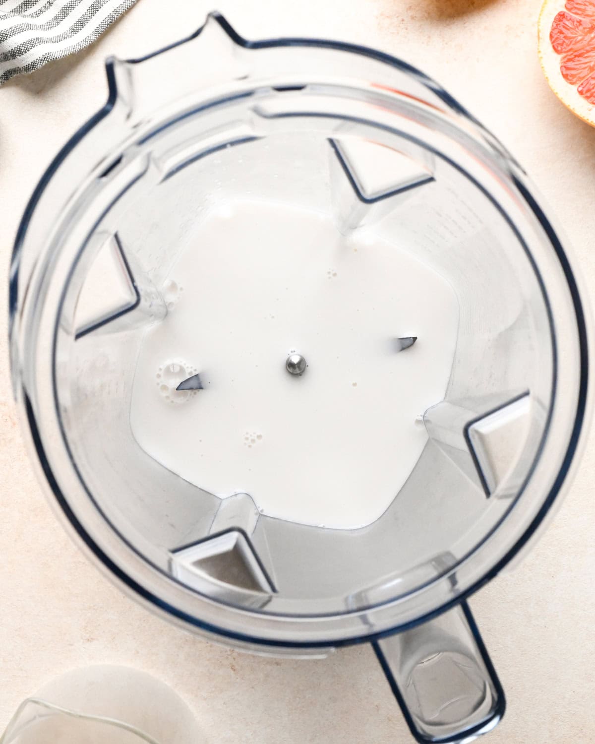 making a grapefruit smoothie: overview photo of milk in a blender.