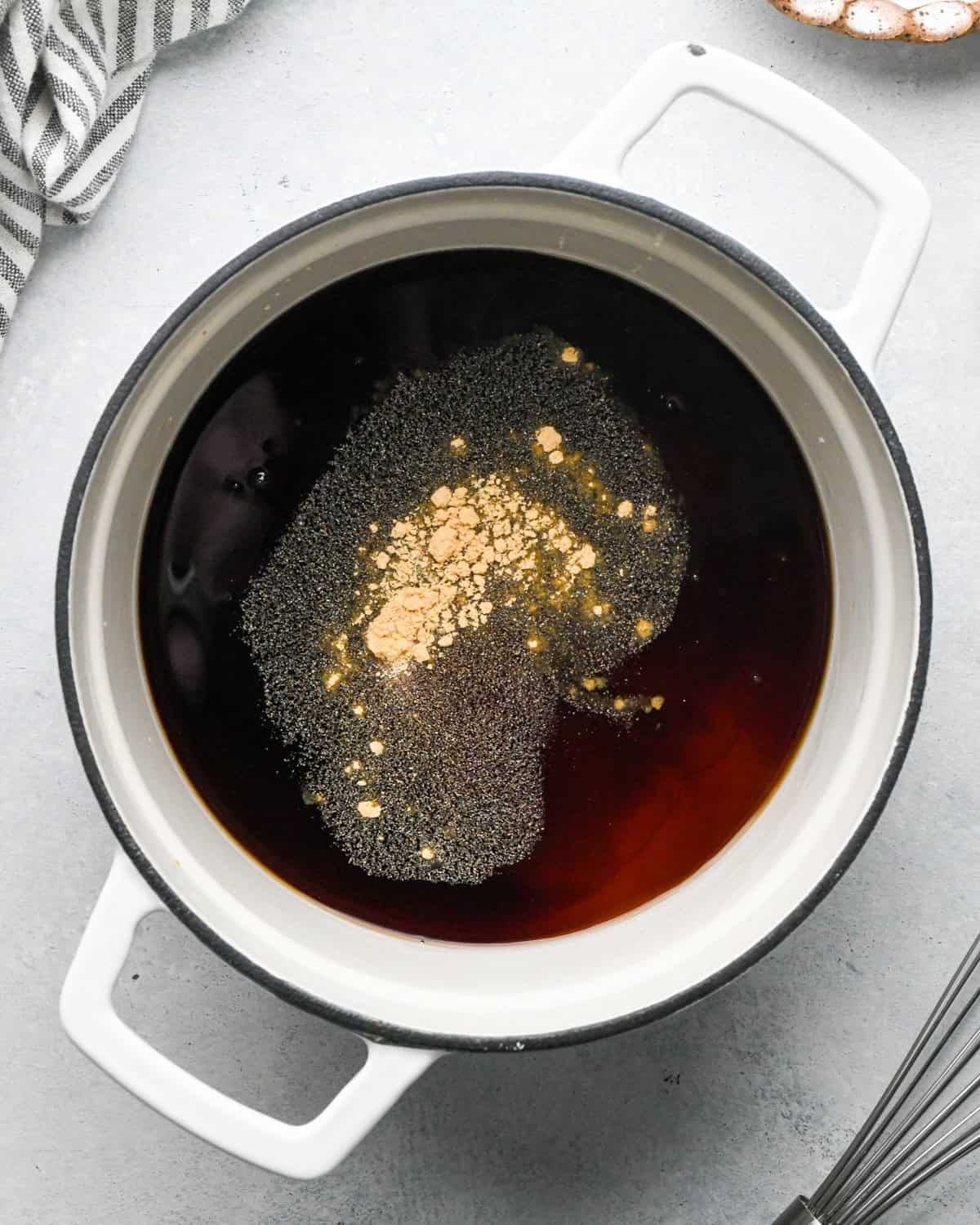 Making teriyaki sauce: overhead photo of sauce ingredients in a white skillet.