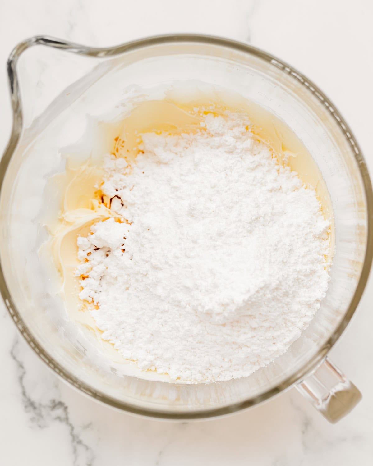 How to Make flag cake frosting - adding powdered sugar and vanilla before mixing