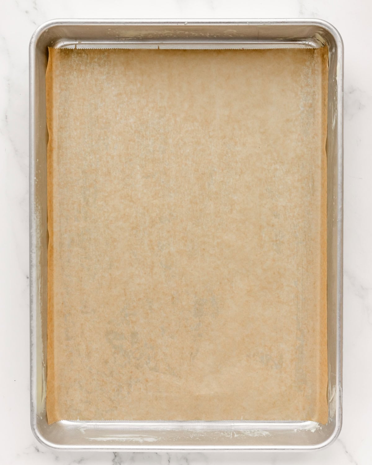 a sheet pan lined with parchment paper and greased