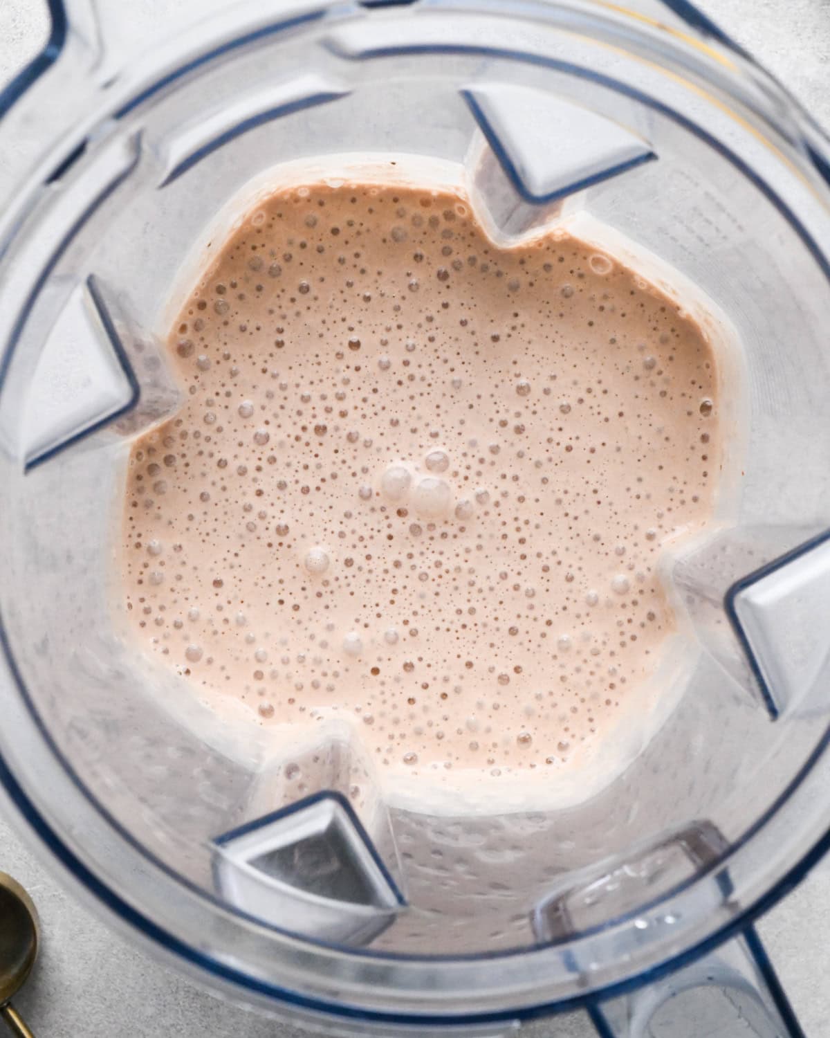 making chocolate banana smoothie: overhead photo of a blender with all ingredients blended together.