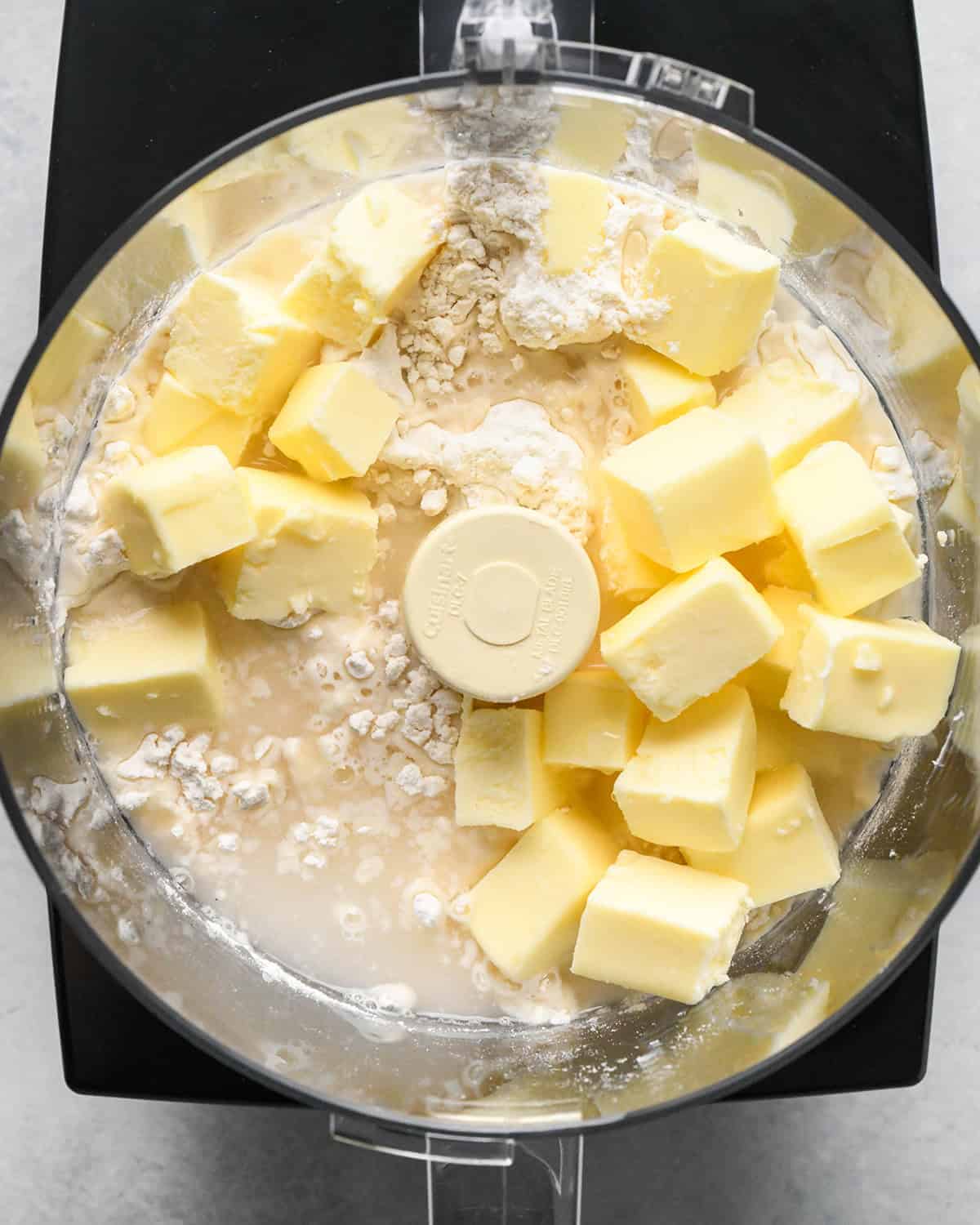 homemade pie dough ingredients in a food processor before processing