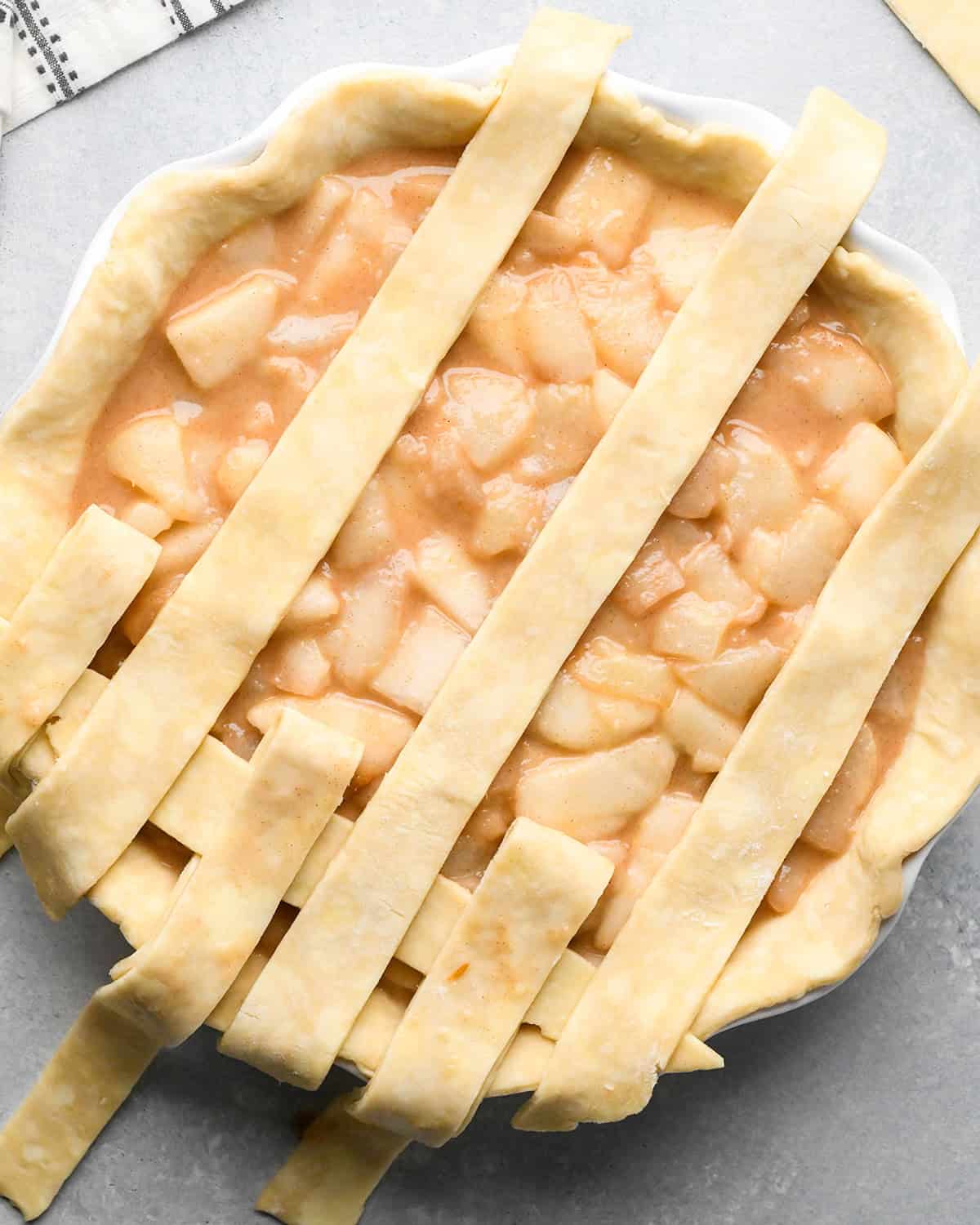photo showing how to make a lattice pie crust - adding the second strip