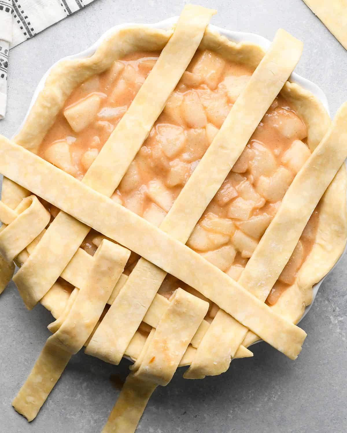 photo showing how to make a lattice pie crust - adding the second strip