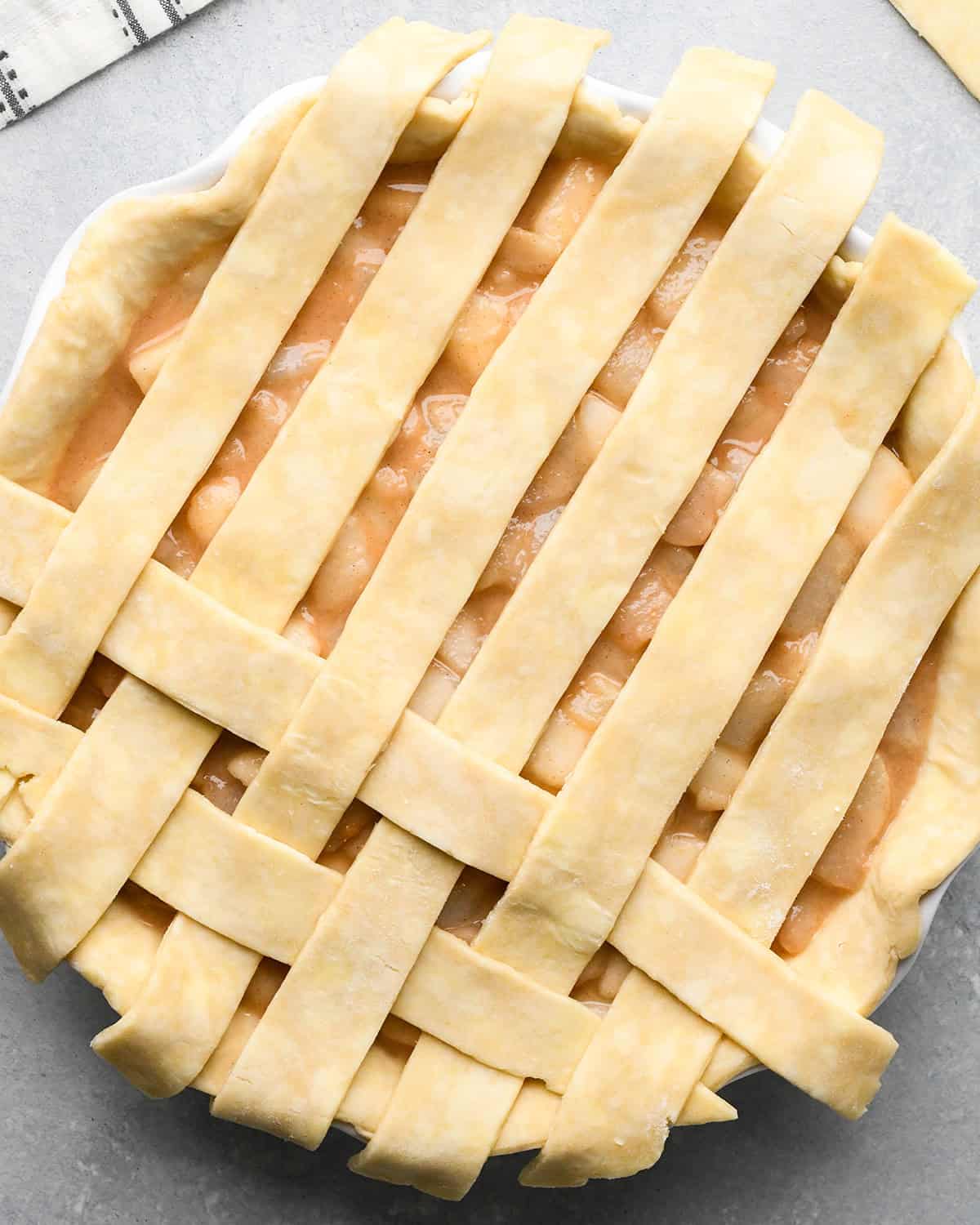 photo showing how to make a lattice pie crust - adding the second strip
