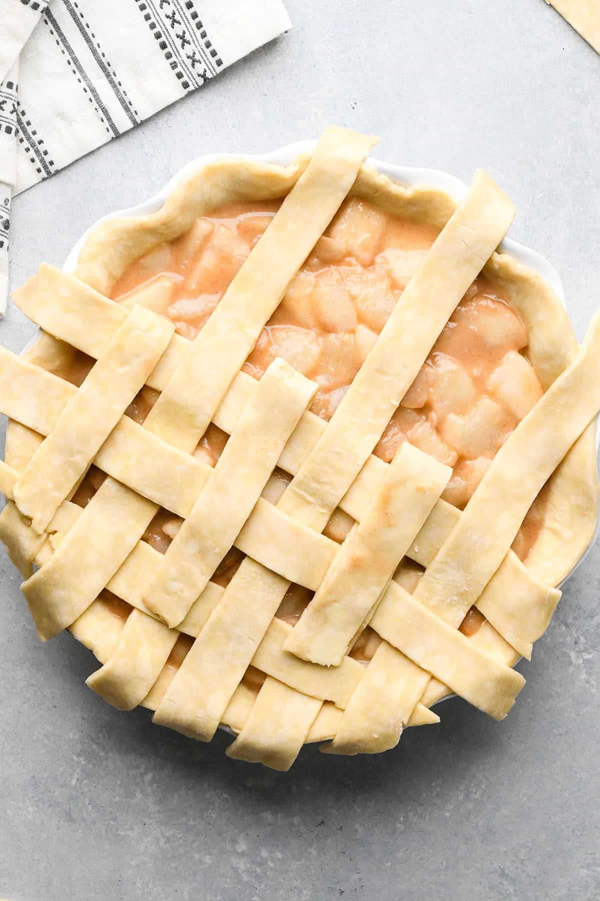 photo showing how to make a lattice pie crust - adding the fourth vertical strip