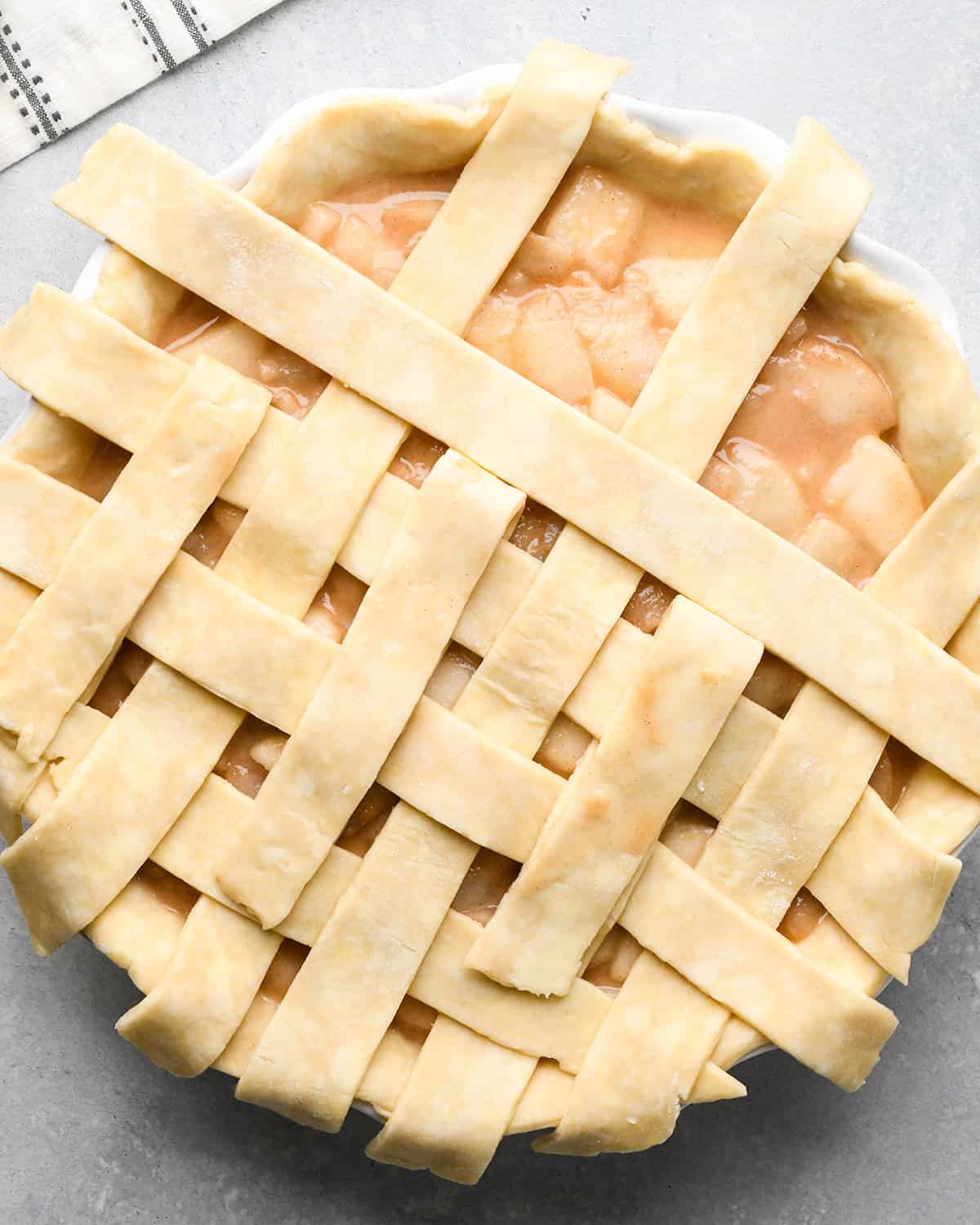 photo showing how to make a lattice pie crust - adding the fourth vertical strip