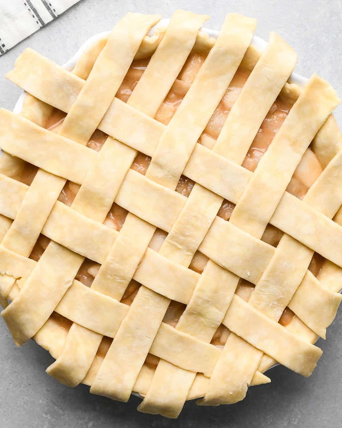 photo showing how to make a lattice pie crust - adding the fourth vertical strip