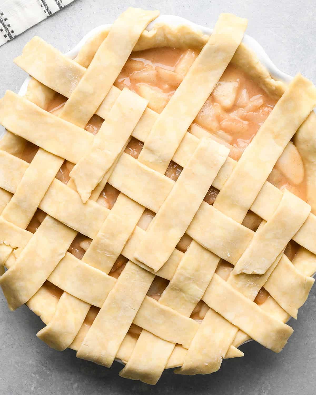 photo showing how to make a lattice pie crust - adding the fifth vertical strip