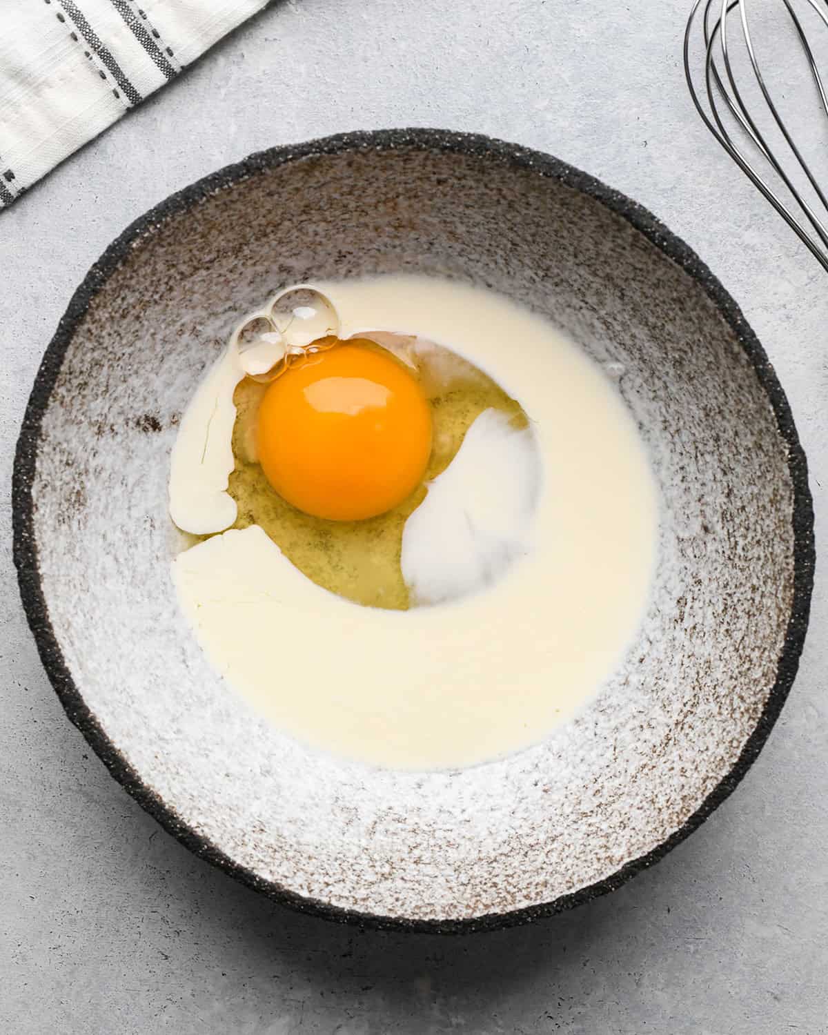 How to Make a Lattice Pie Crust - egg wash ingredients in a bowl before whisking