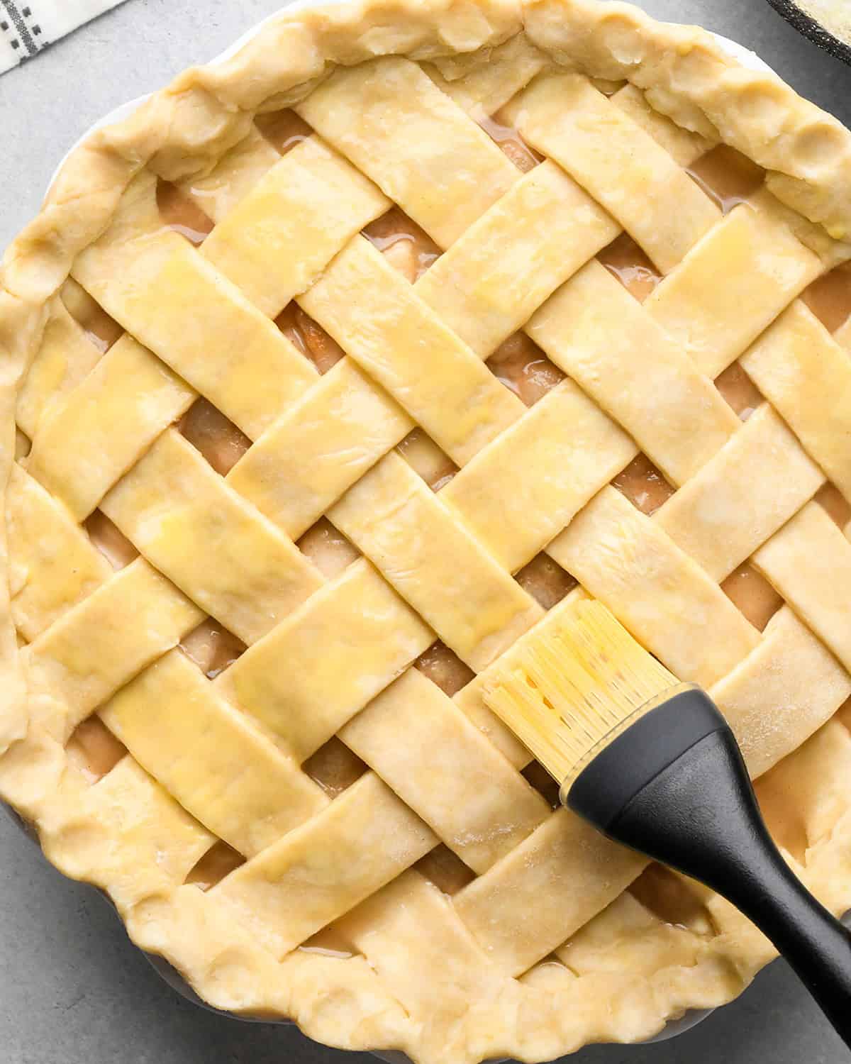 How to Make a Lattice Pie Crust - brushing egg wash onto the pie
