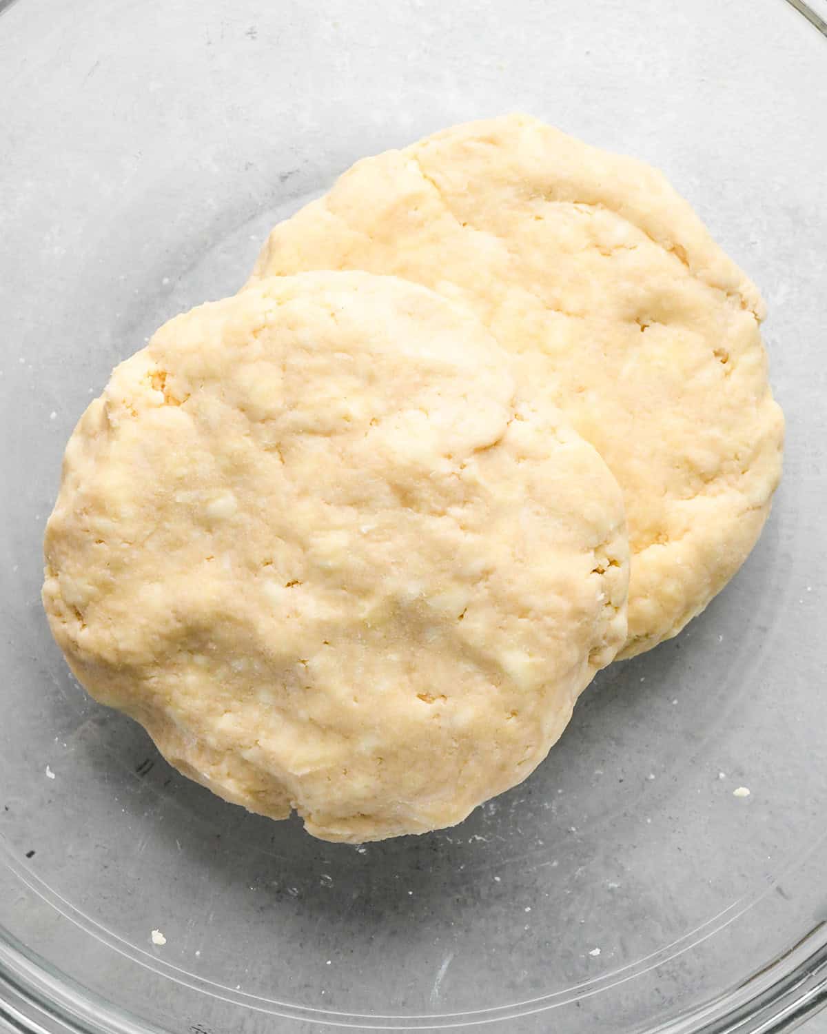 making homemade pie crust - two discs of dough in a bowl