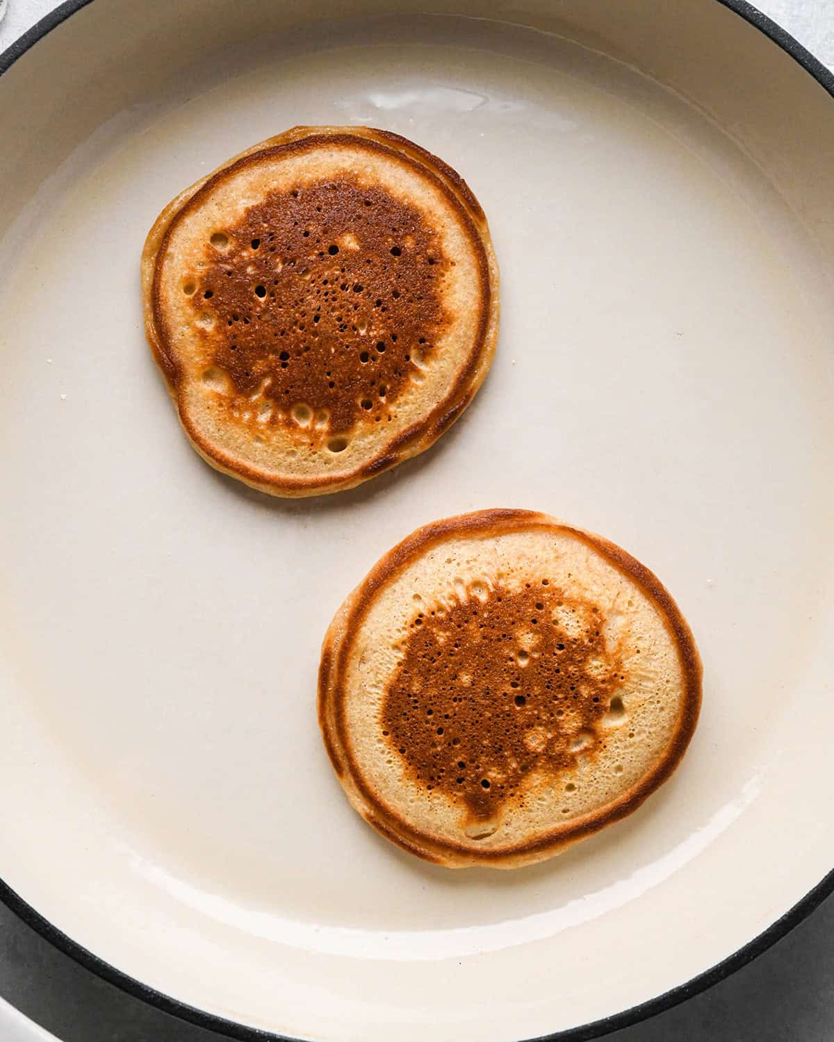 oat flour pancakes cooking on the second side